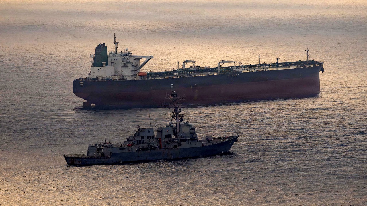 This US Navy handout photo shows the Arleigh Burke-class guided-missile destroyer USS Rafael Peralta (DDG 115) implementing a maritime blockade against the Iran-flagged crude oil tanker vessel Herby while the latter was attempting to sail toward an Iranian port. /US Navy/AFP