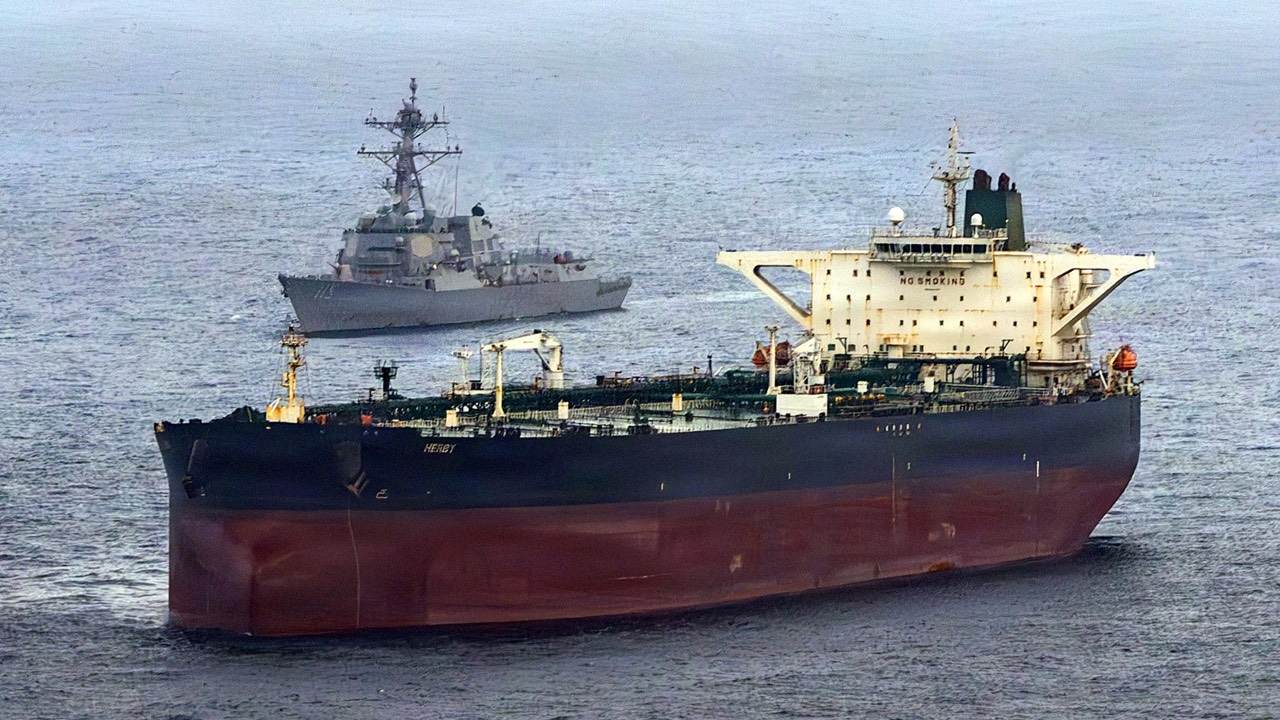 The Arleigh Burke-class guided-missile destroyer USS Rafael Peralta (DDG 115) implementing a maritime blockade against the Iran-flagged crude oil tanker vessel Herby while the latter was attempting to sail toward an Iranian port. /US Navy/AFP