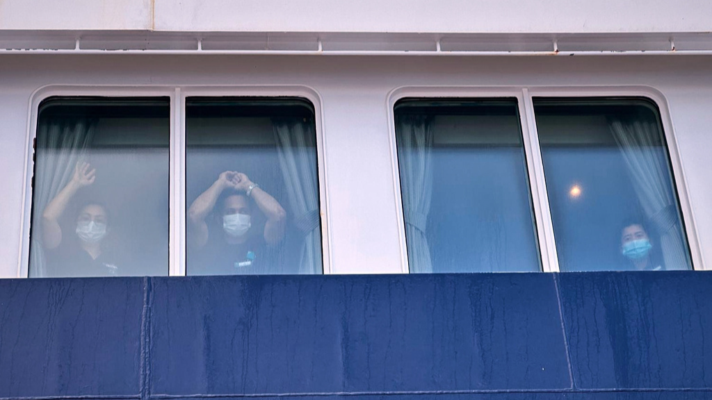 Passengers watch as others are disembarked from the hantavirus-stricken cruise ship MV Hondius at the port of Granadilla in Tenerife, Canary Islands, Spain, Sunday, May 10, 2026. /AP