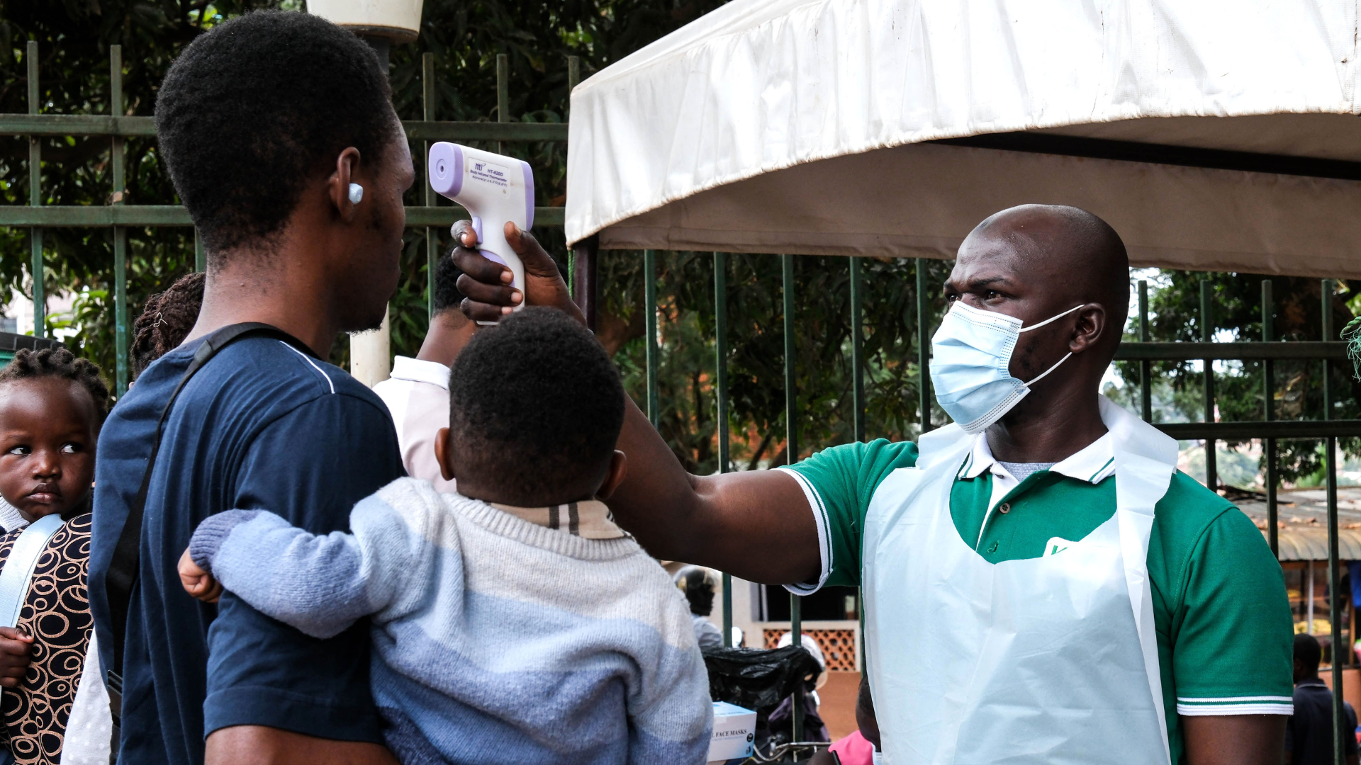 A health official uses a thermometer to screen people at Kibuli Muslim Hospital in Kampala, Uganda on Saturday./ Hajjarah Nalwadda/AP
