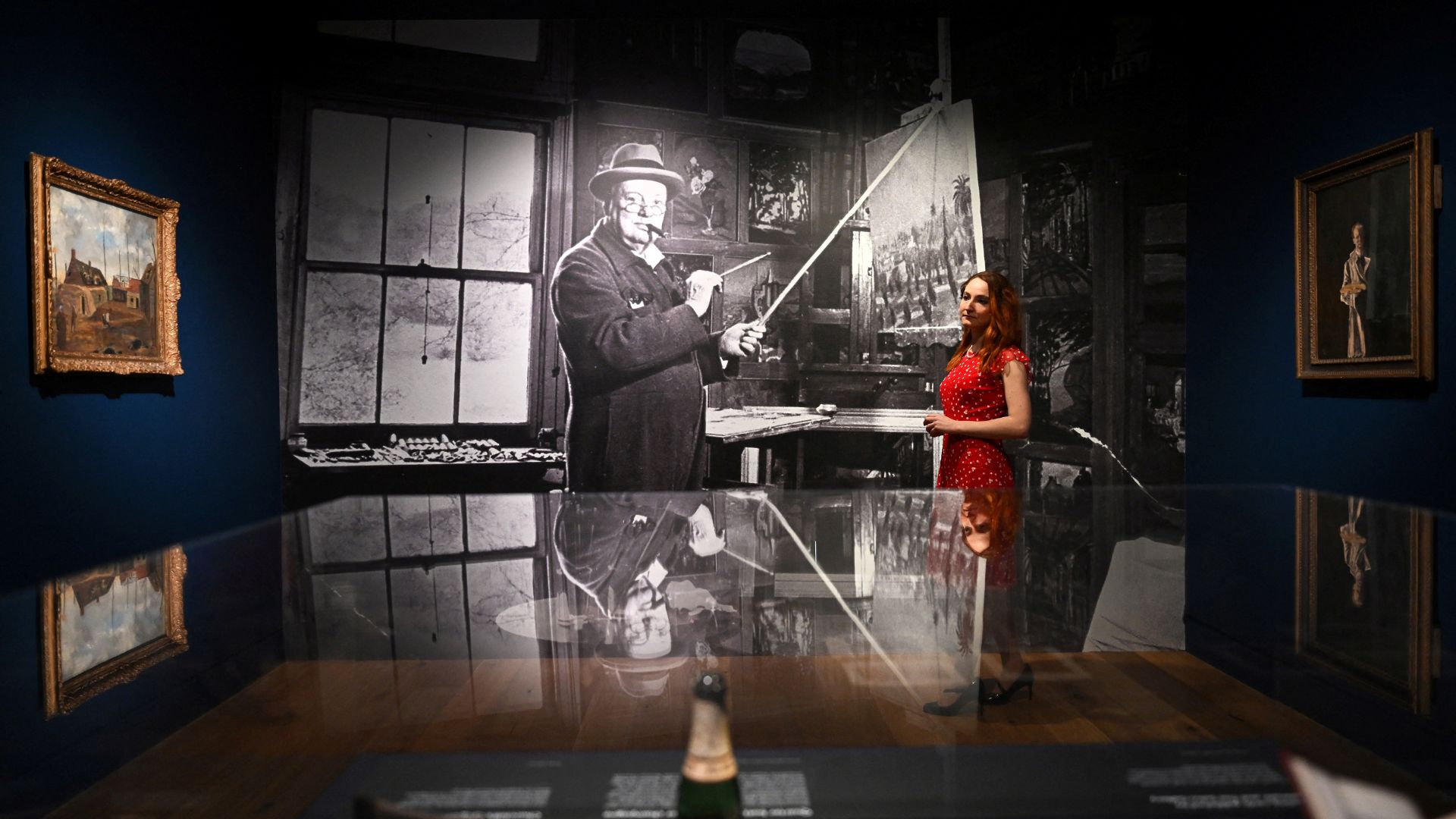 A gallery assistant poses alongside a portrait by photographer Hans Wild at the Wallace Collection. /Justin Tallis/AFP
