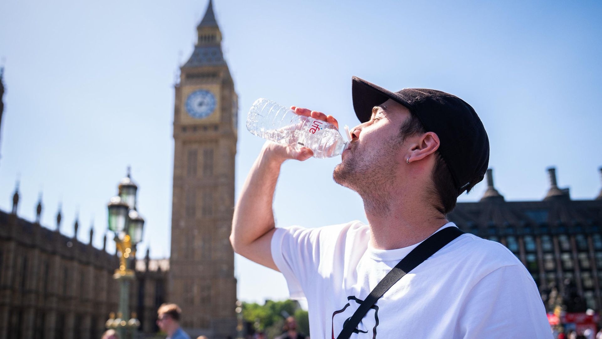 A man cools down with a bottle of water on London's Westminster Bridge on Monday. /CFP