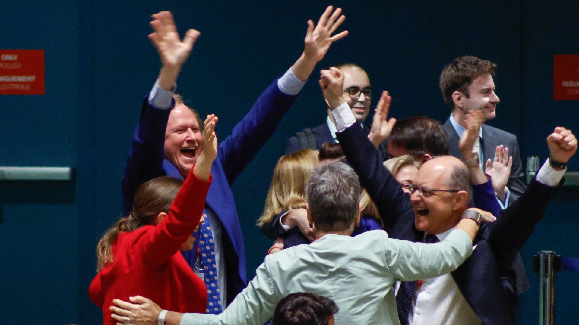Representatives from Austria, including Austrian Ambassador to the UN Gregor Koessler (lower R), react after winning a seat as a non-permanent member of the UN Security Council. /Kena Betancur/AFP

