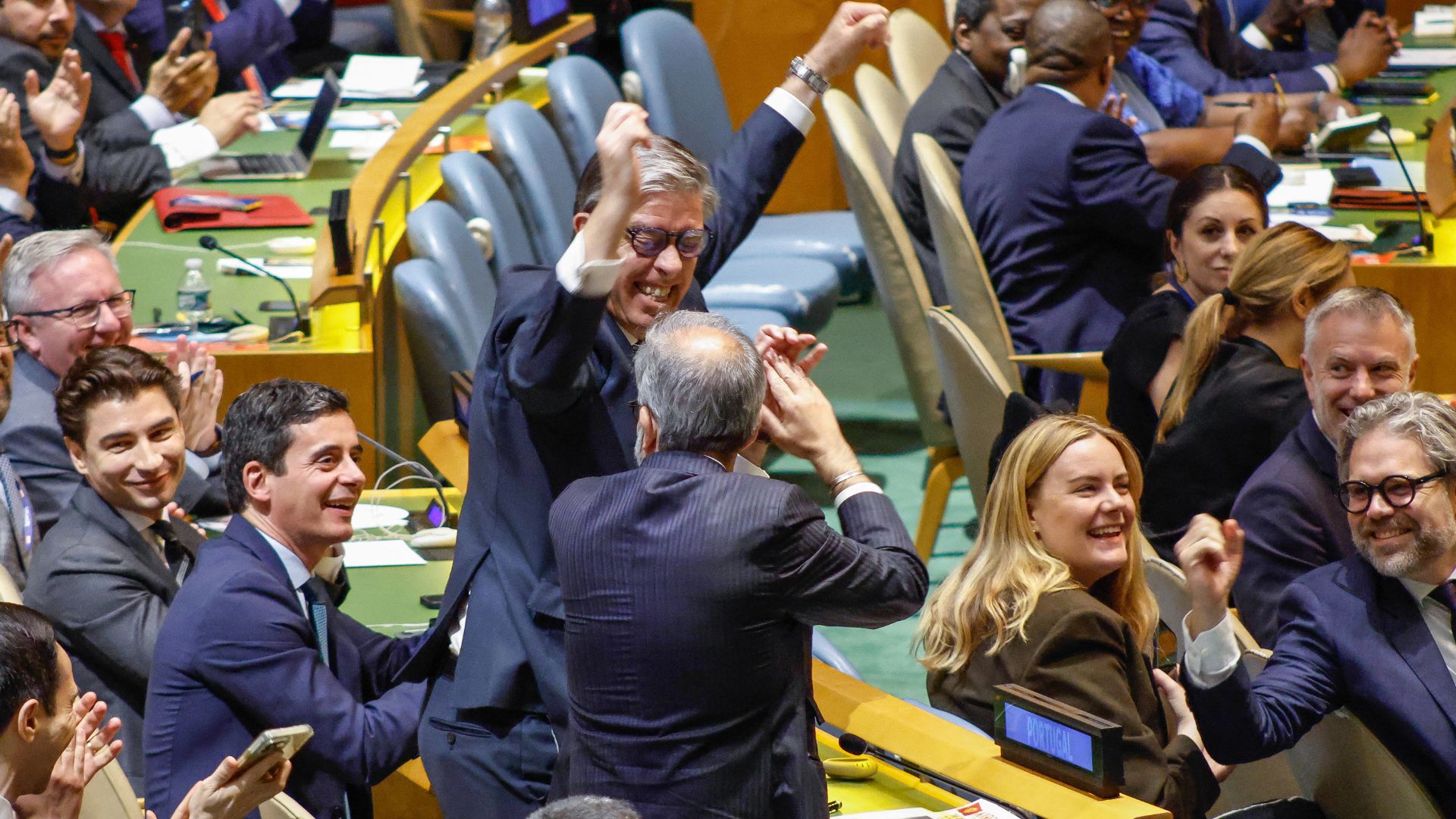 Portuguese Ambassador to the UN Rui Vinhas (C) gestures in celebration after his country won a seat as a non-permanent member of the UN Security Council. /Kena Betancur/AFP
