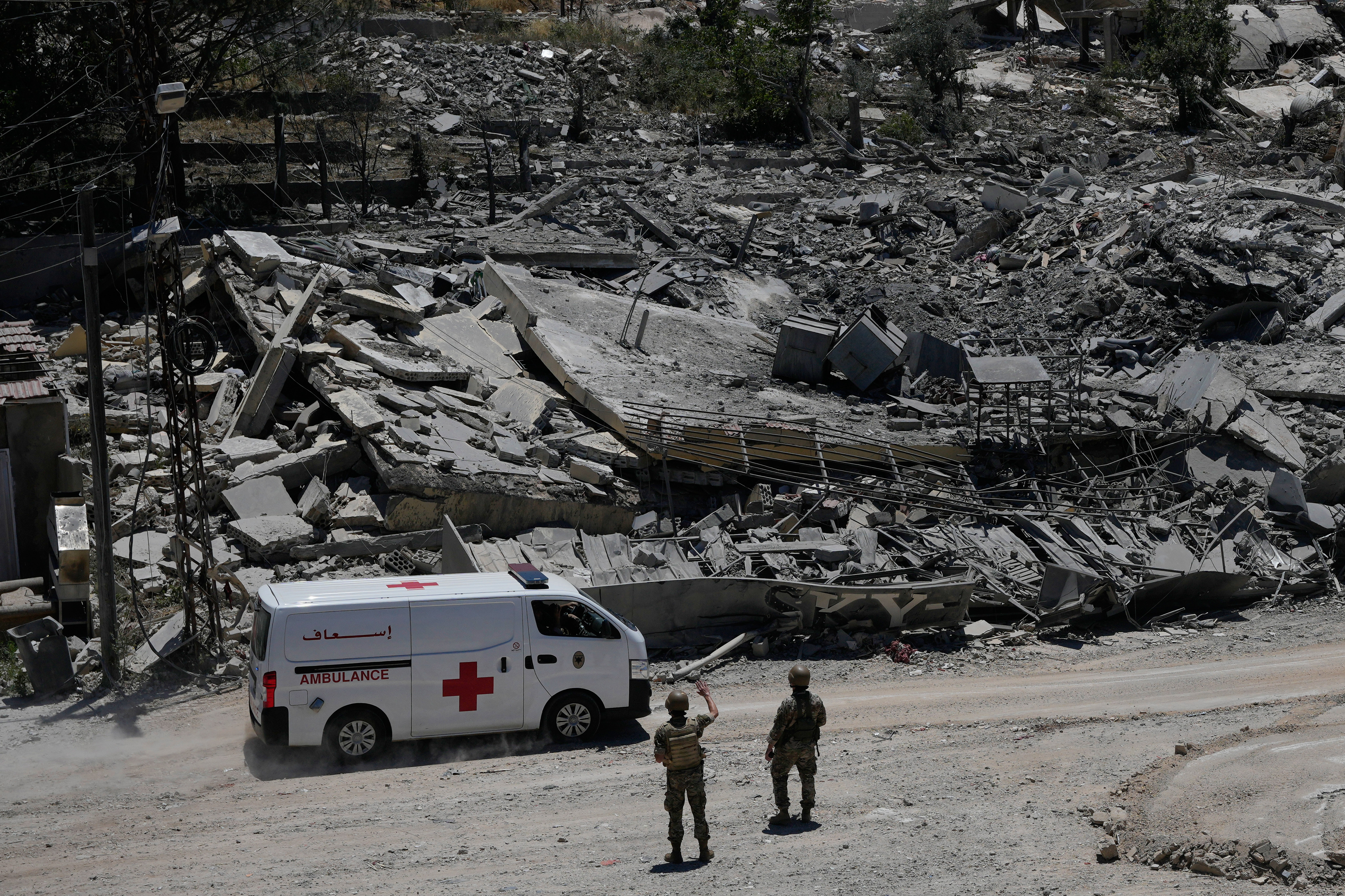 Lebanese soldiers deploy at a road in front of destroyed houses in Dibbine village, southeast Lebanon, after Israeli forces withdrew following clashes with Hezbollah fighters. /Hussein Malla/AP