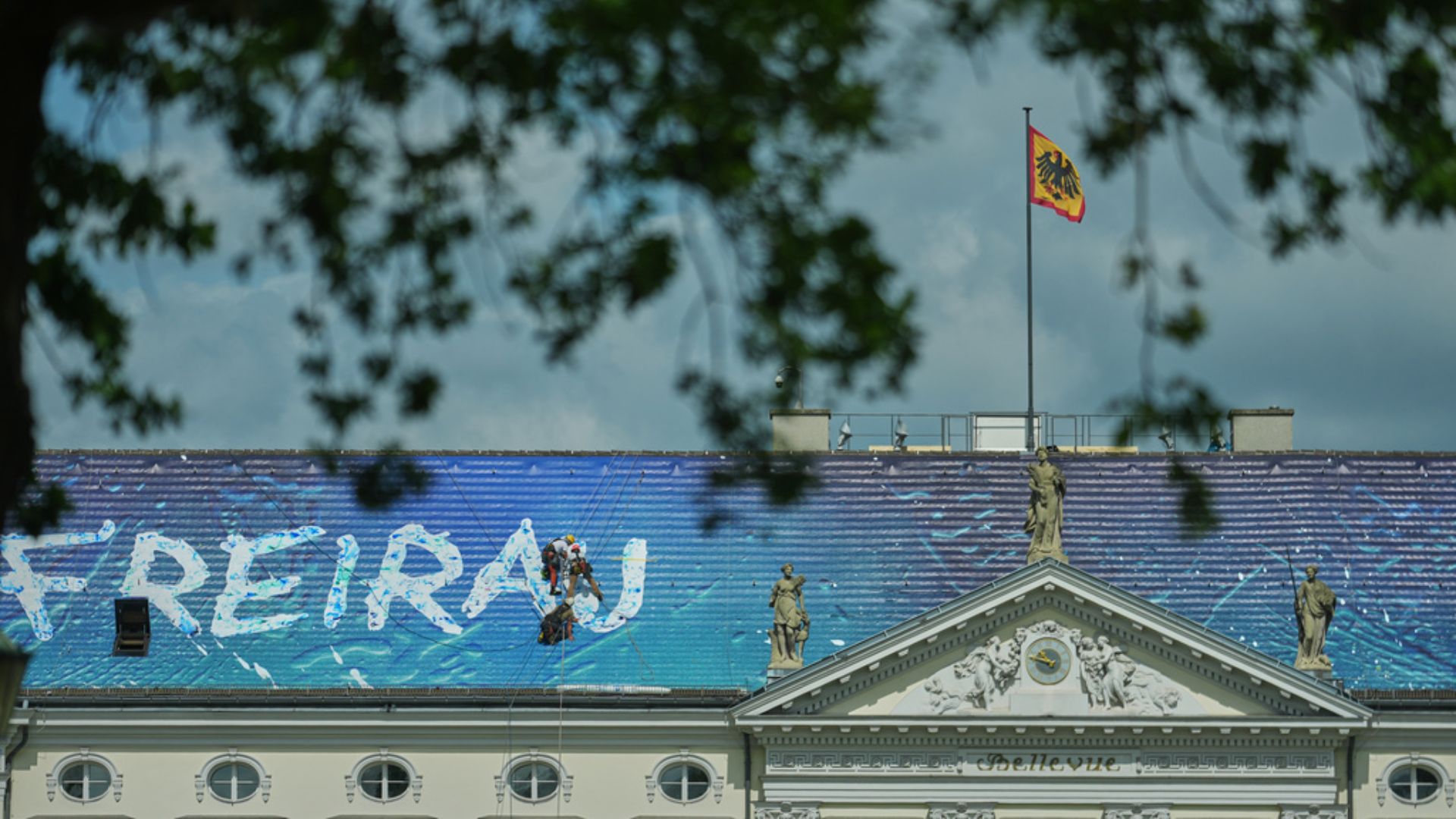 Workers install the artwork 