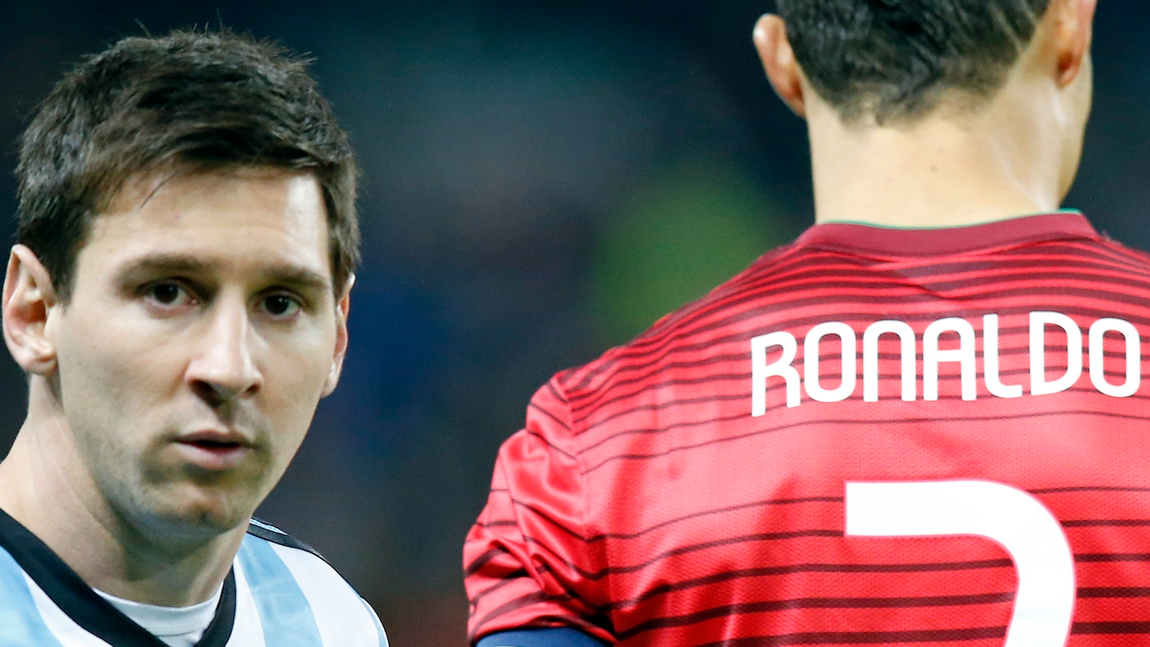 Lionel Messi of Argentina, left, stands next to Cristiano Ronaldo of Portugal before their International Friendly soccer match at Old Trafford Stadium, Manchester, England, Nov. 18, 2014. /AP Photo
