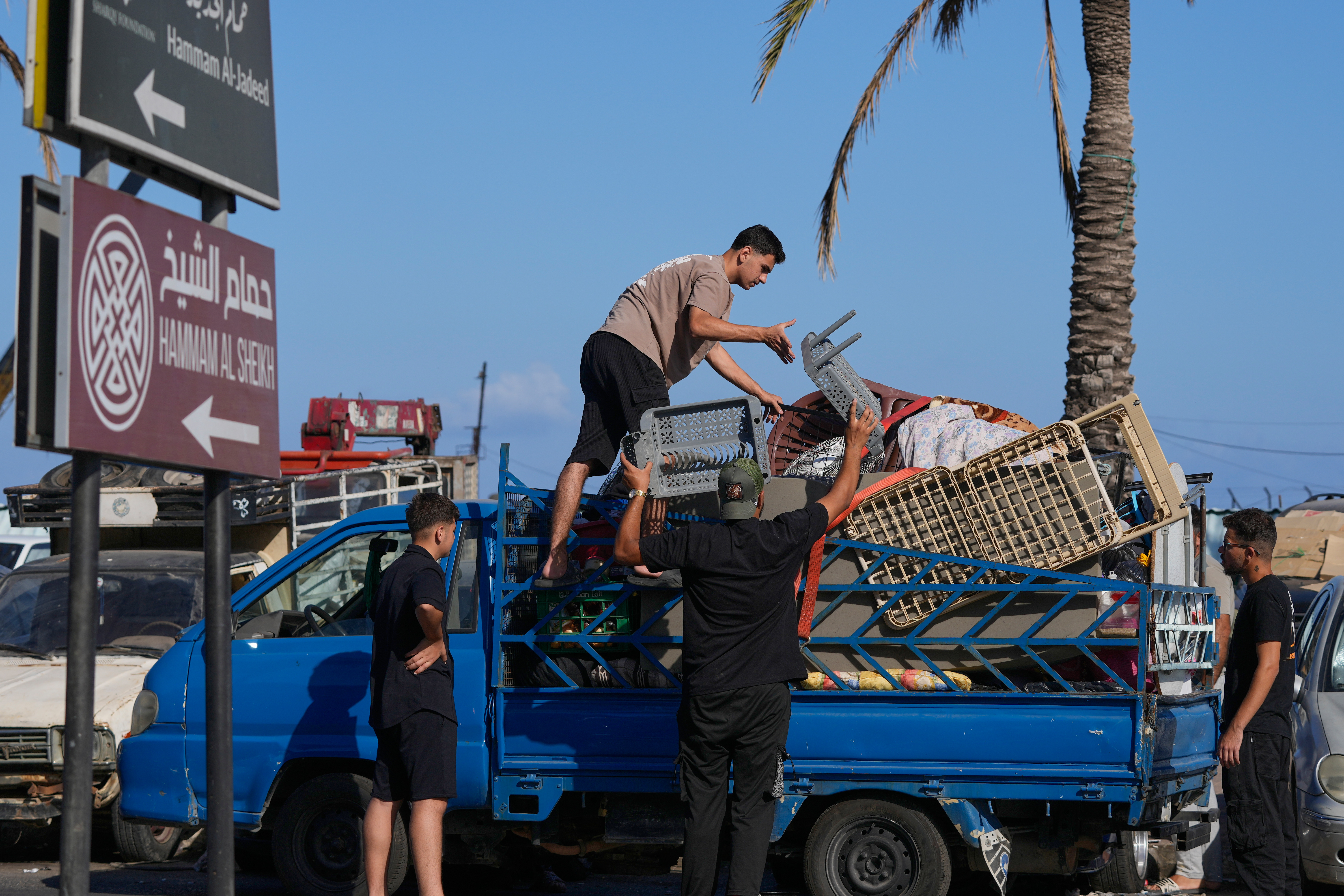 Displaced people pack their belongings in Sidon, Lebanon, as they prepare to return to their village following the announcement of an initial ceasefire agreement between the United States and Iran. /Mohammed Zaatari/AP