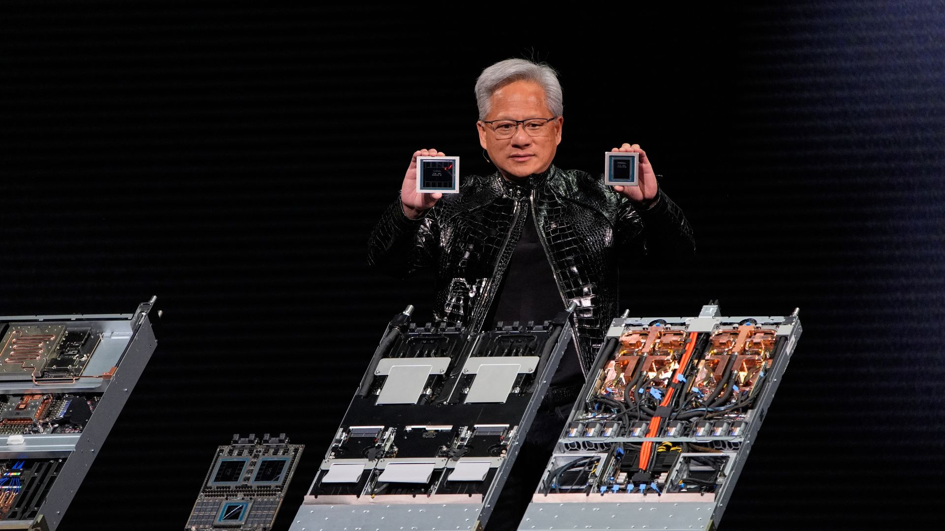 Nvidia founder and CEO Jensen Huang holds up a Rubin GPU and a Vera CPU as he speaks during a Nvidia news conference. (AP Photo/John Locher)