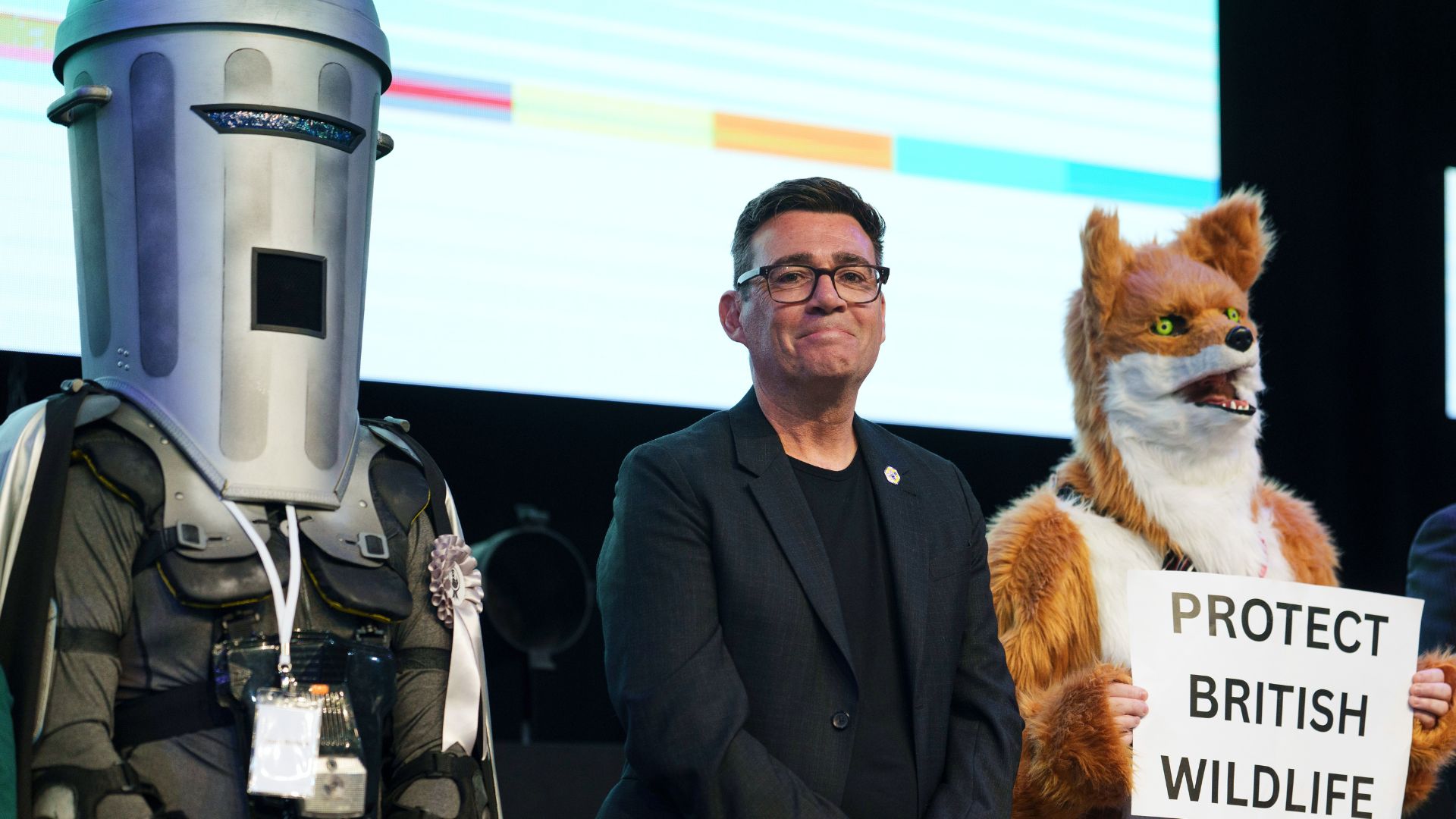 Andy Burnham (C) stands alongside two other candidates for Makerfield MP, Count Binface (L) and Protect the Wild founder Robert Pownell (R). Perhaps the only thing that stays the same in British politics is the presence of costumed candidates. /AP