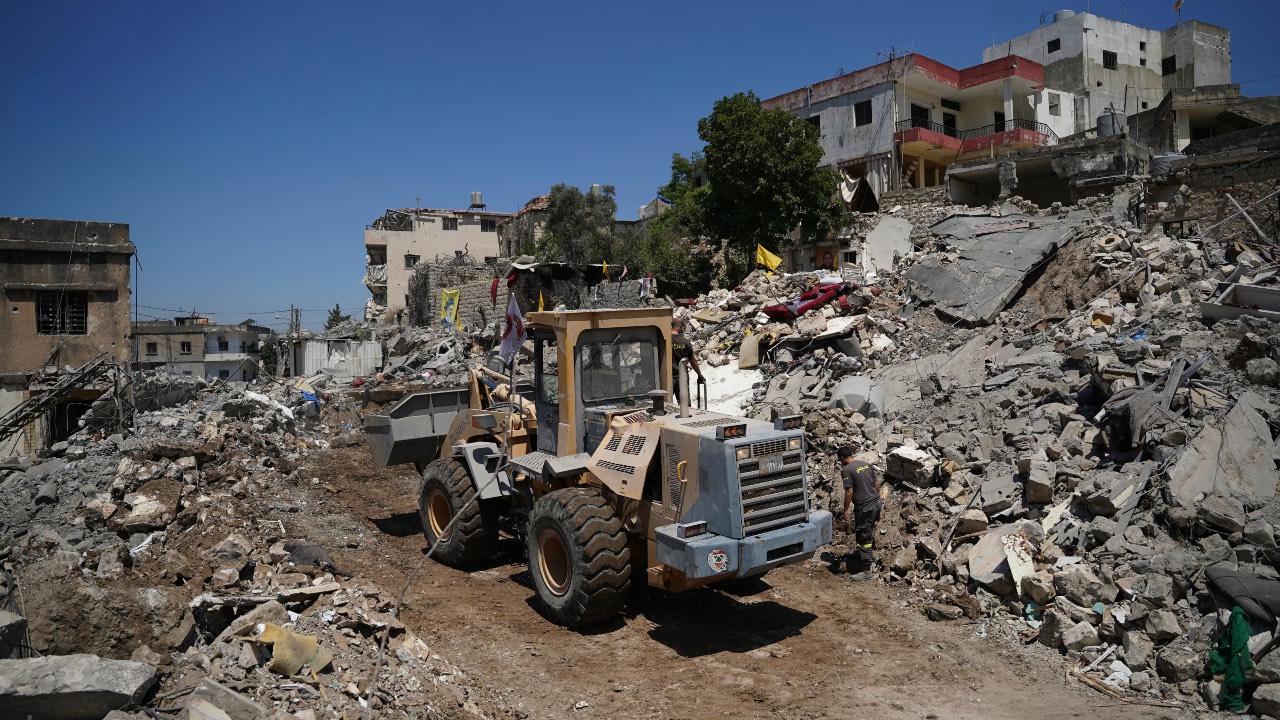 A bulldozer removes the rubble from businesses and home destroyed by the Israeli military in the southern Lebanese city of Nabatieh. /Abbas Fakih/AFP