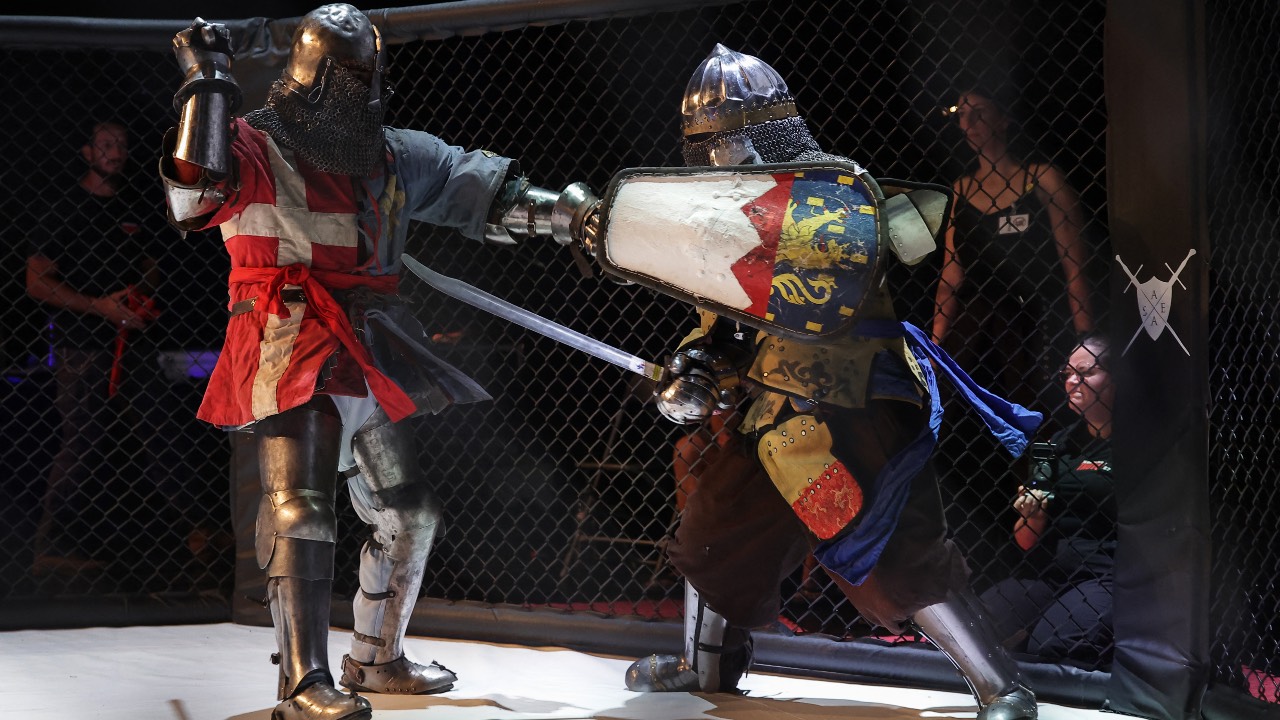 Competitors fight in an MMA arena during the Knights of the Cage, a gala of a medieval armored combat or behourd,. /Valentine Chapius/AFP