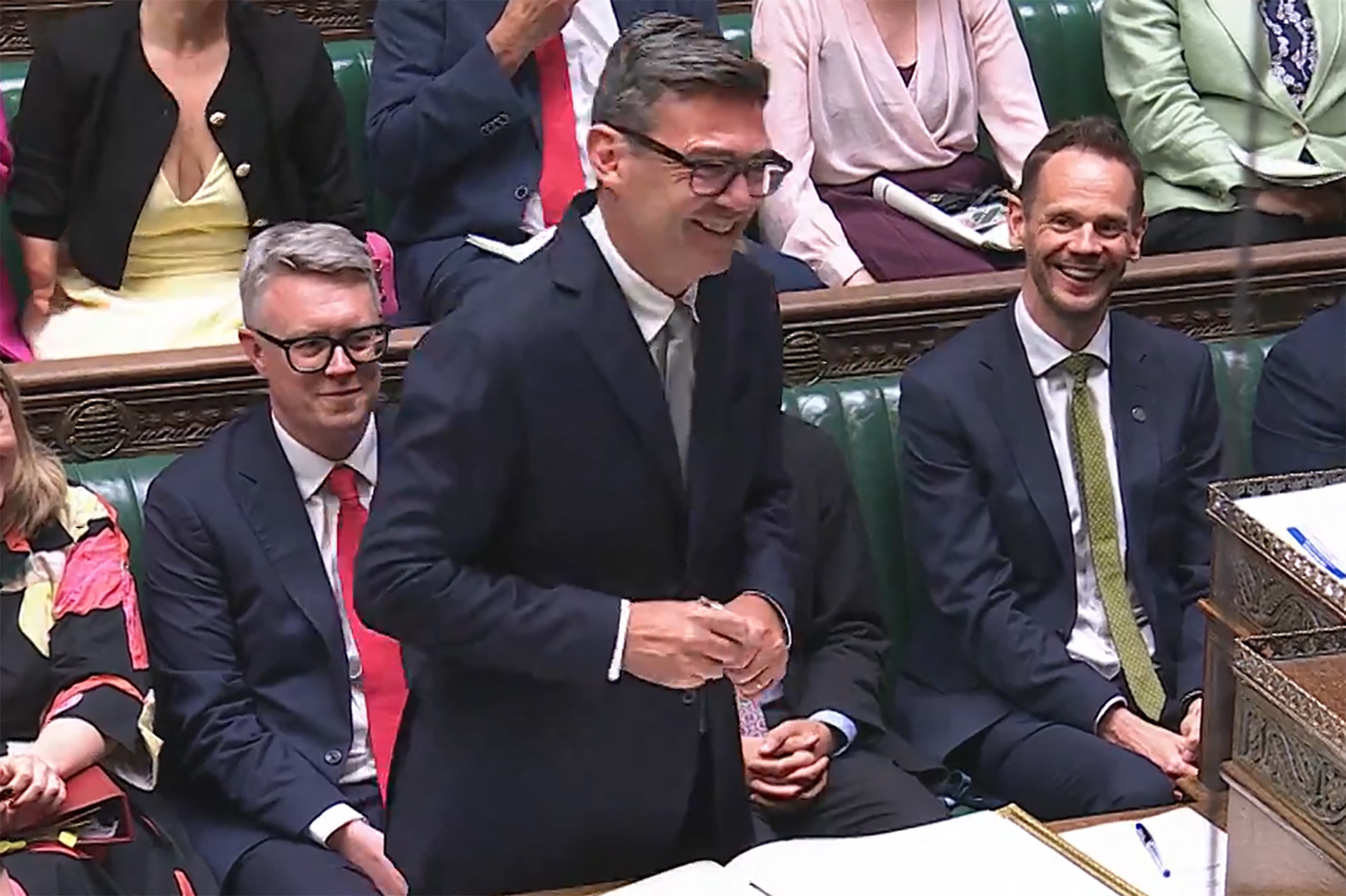 In this video grab taken from footage broadcast by the UK Parliamentary Recording Unit (PRU) via the Parliament TV website on June 22, 2026, new Labour Party MP for Makerfield, Andy Burnham smiles after signing the book having been sworn in after his win in the recent by-election. /PRU/AFP
