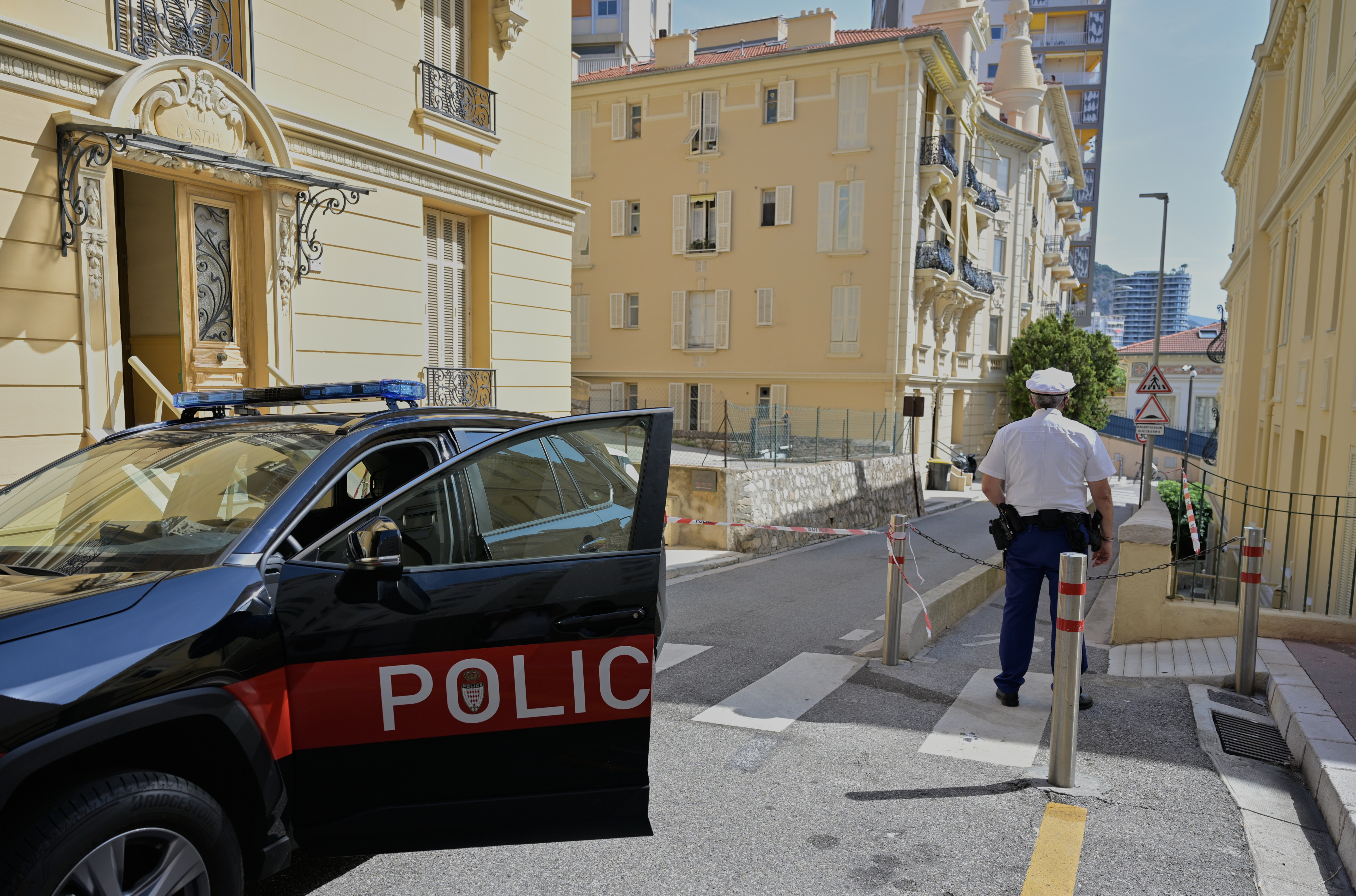 A police officer guards in a street in Monaco, Tuesday, June 30, 2026, a day after an explosive device seriously injured three people at a residential building in Monaco. /Philippe Magoni/AP