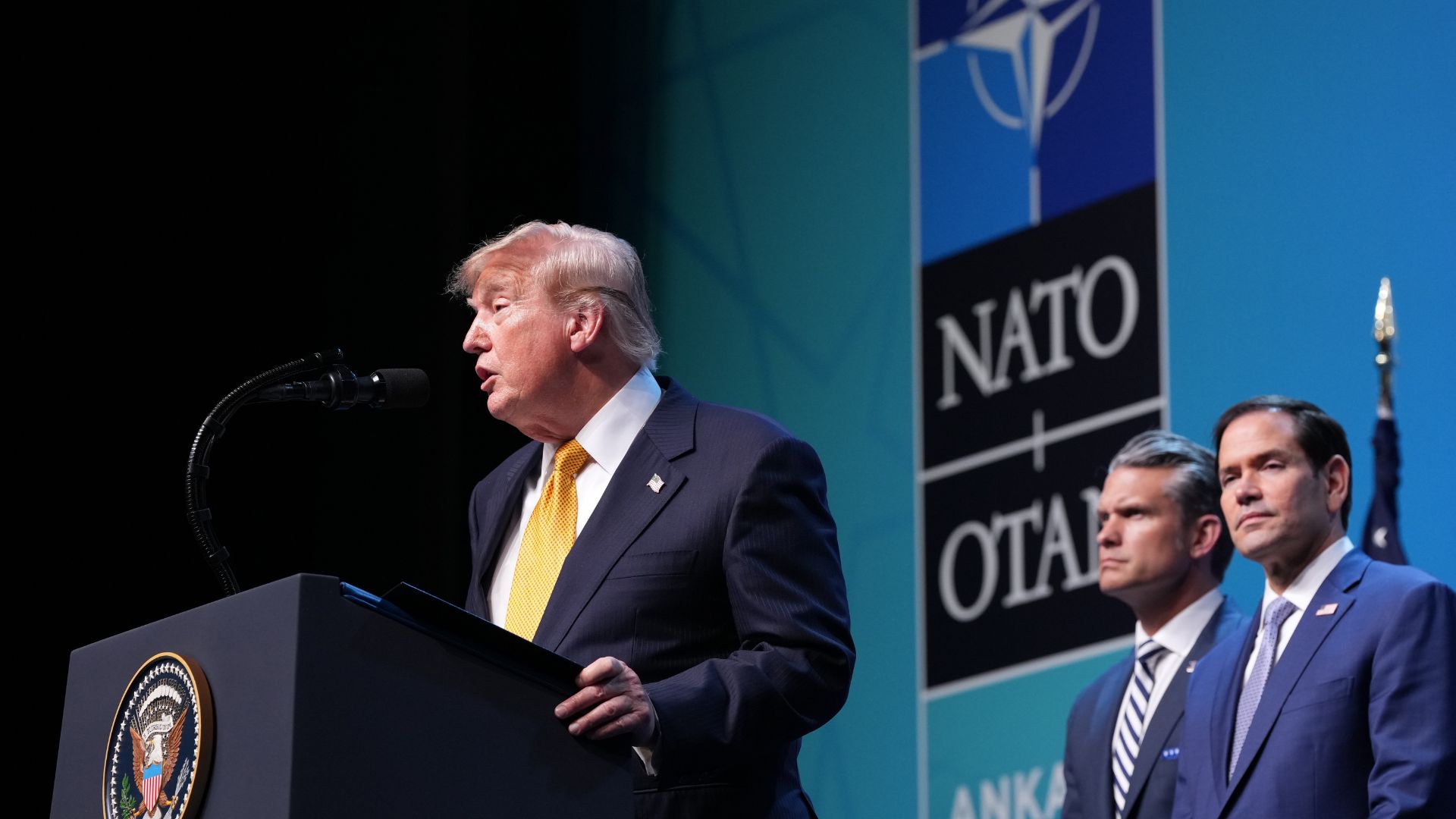 US Secretary of State Marco Rubio and Secretary of War Pete Hegseth watch on as President Donald Trump speaks at the NATO summit in Ankara, Türkiye, on Wednesday. /AP.