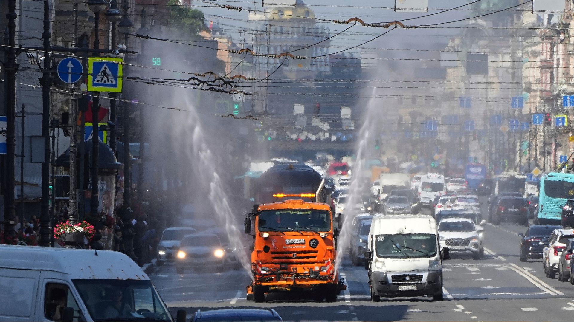A water truck sprays water to cool down roads and residents on a hot day on Nevsky Prospect, the city's central avenue in St. Petersburg, Russia. /Dmitri Lovetsky/AP File
