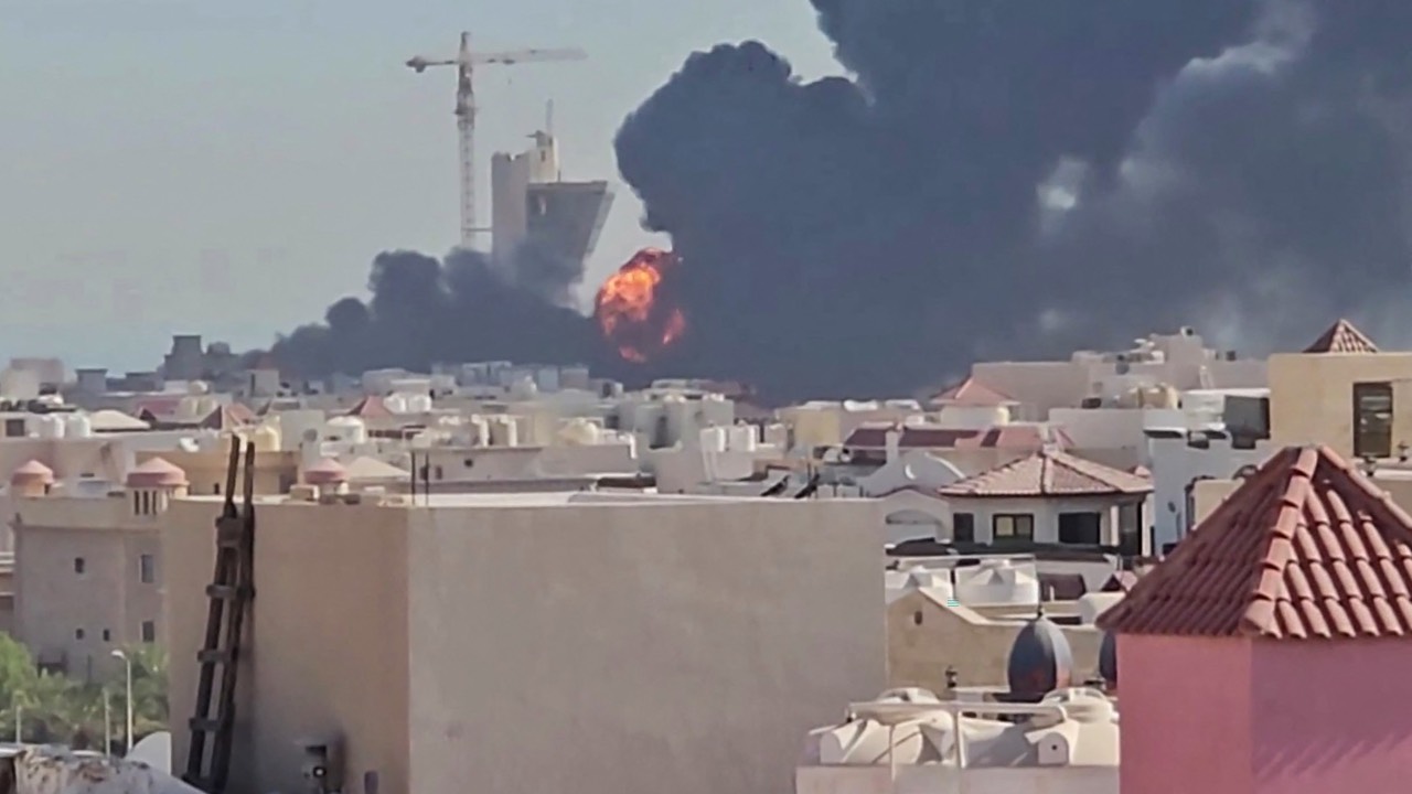 A plume of black smoke and flames can be seen billowing over the town of Mangaf, south of Kuwait City. /AFP