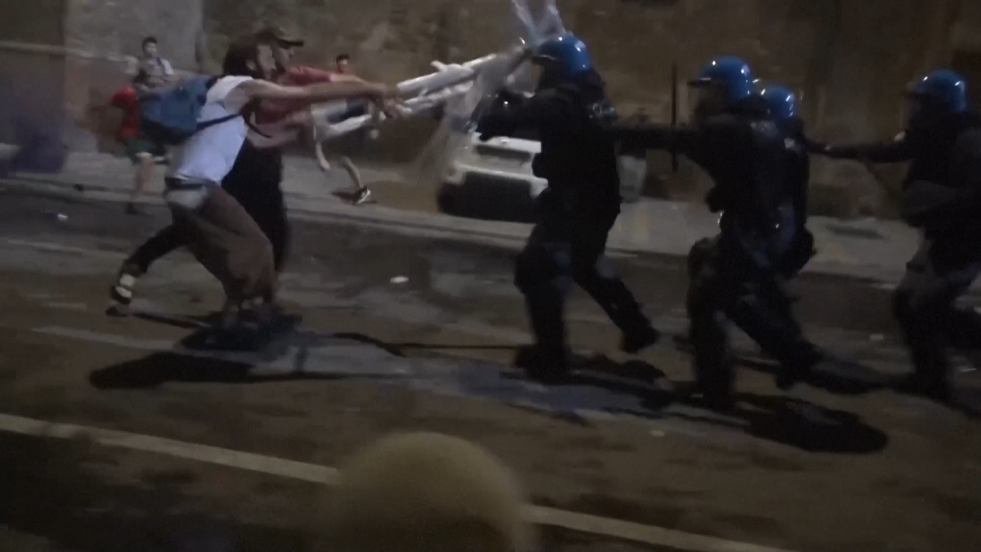 Protesters hit riot police on the streets of Bologna. /AGTW/Reuters
