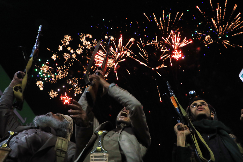 Fireworks burst as Houthi supporters rally against the Saudi-led coalition in Sanaa, Yemen. /Osamah Abdulrahman/AP