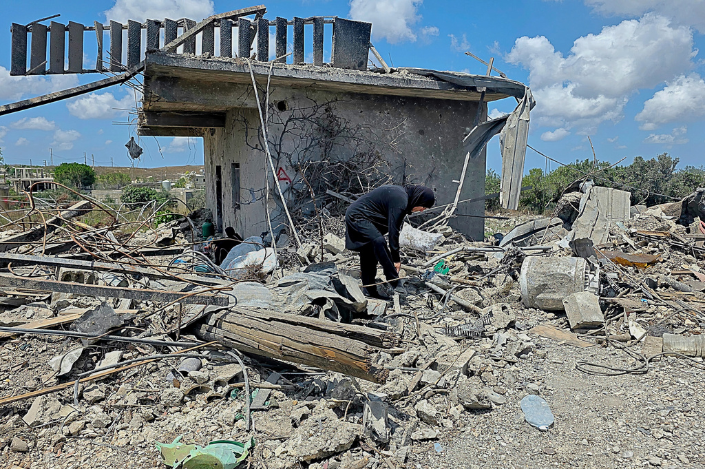 A Lebanese woman clears debris of her destroyed house in the village of Zawtar al-Gharbiyeh, southern Lebanon, Sunday, July 26, 2026. /Ahmad Mantash/AP