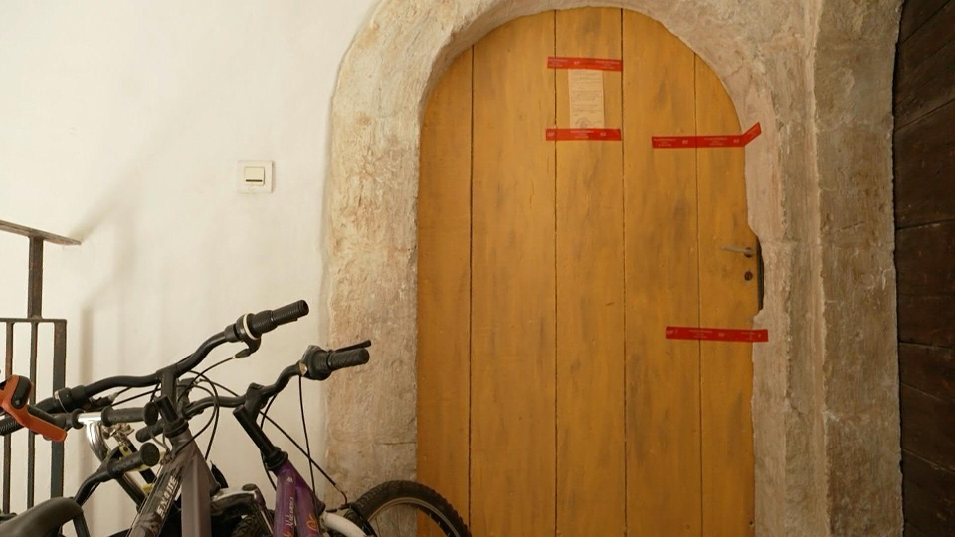 Police tape seals the front door of the home where the bodies were found. /AFP