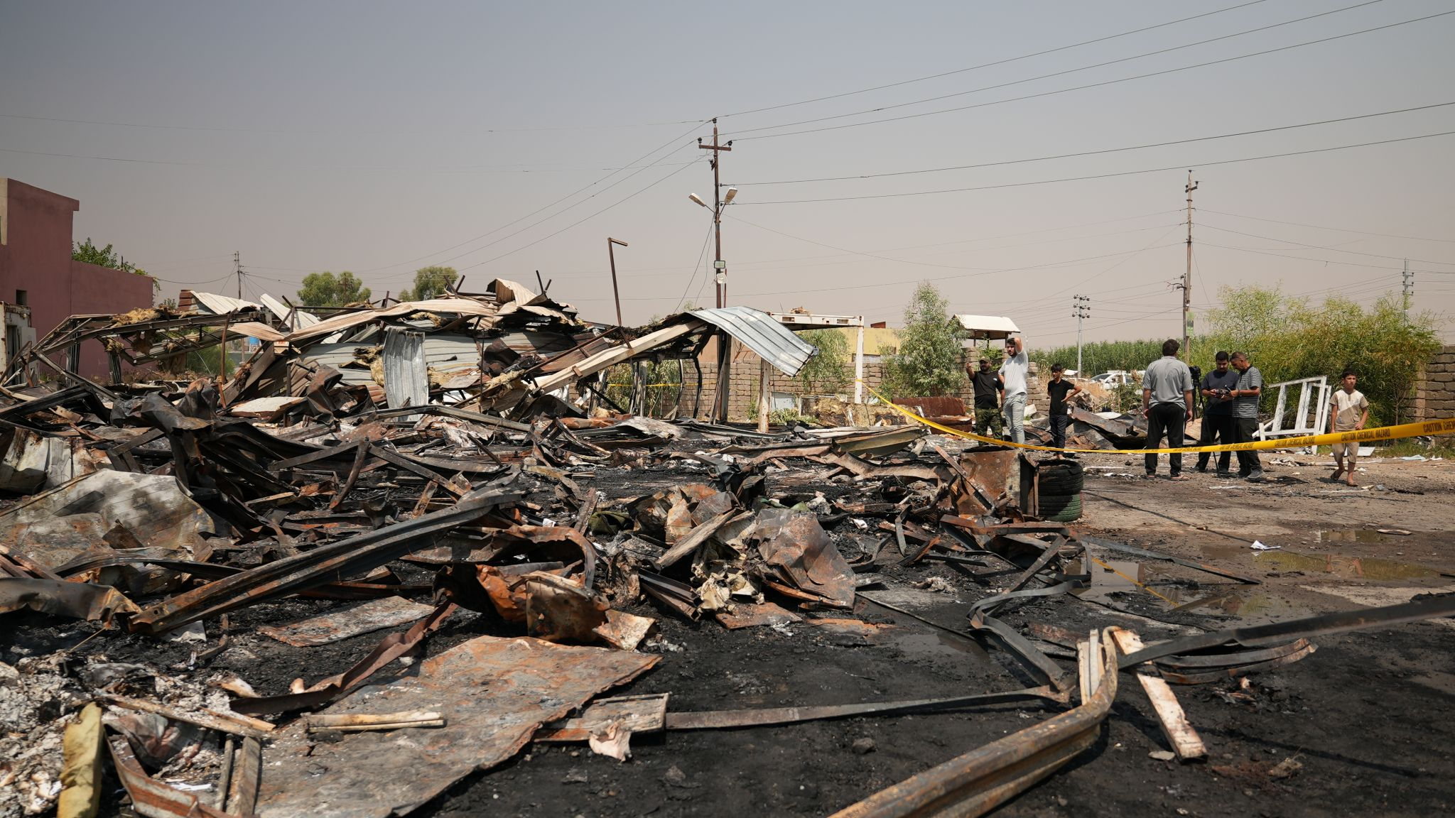Iraqis inspect damaged structures at the site of an airstrike on a Popular Mobilization Forces base in Mosul, Iraq, Wednesday, July 29, 2026. Farid Abdulwahed via AP