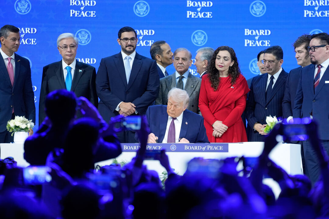 President Donald Trump signs the charter of his Board of Peace initiative in Davos, in January. /Markus Schreiber/AP Photo
