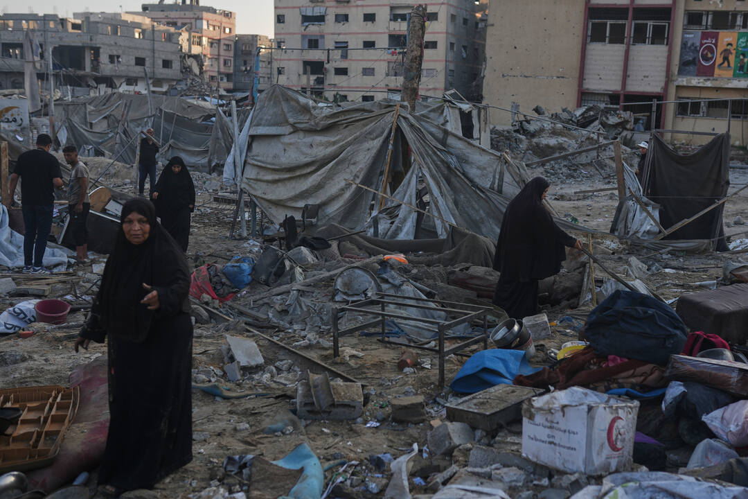 Palestinians salvage their belongings from the rubble of a building and tents destroyed in an Israeli airstrike in Gaza City, Thursday, July 30, 2026. /Jehad Alshrafi/AP Photo