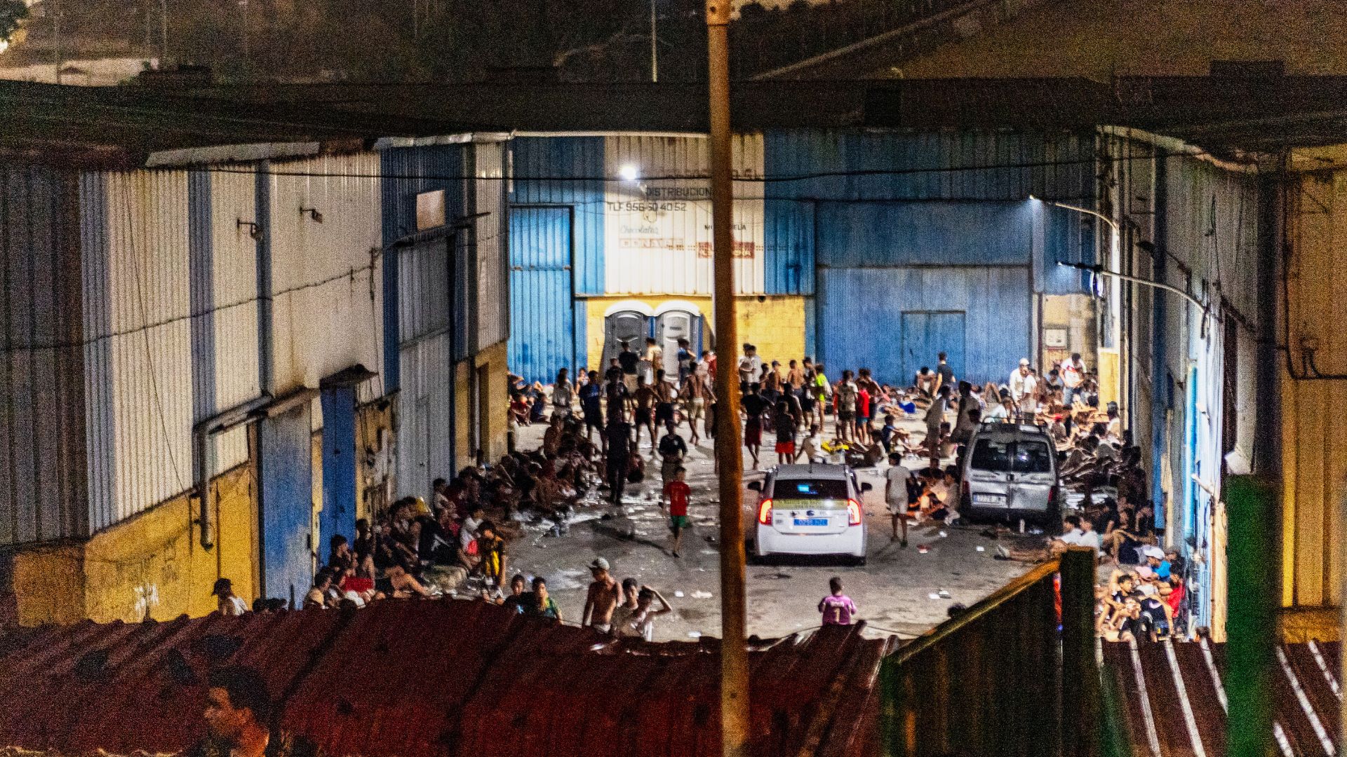 Migrants spend the night on the streets after crossing from Morocco into the Spanish enclave of Ceuta. /Antonio Sempere/AP
