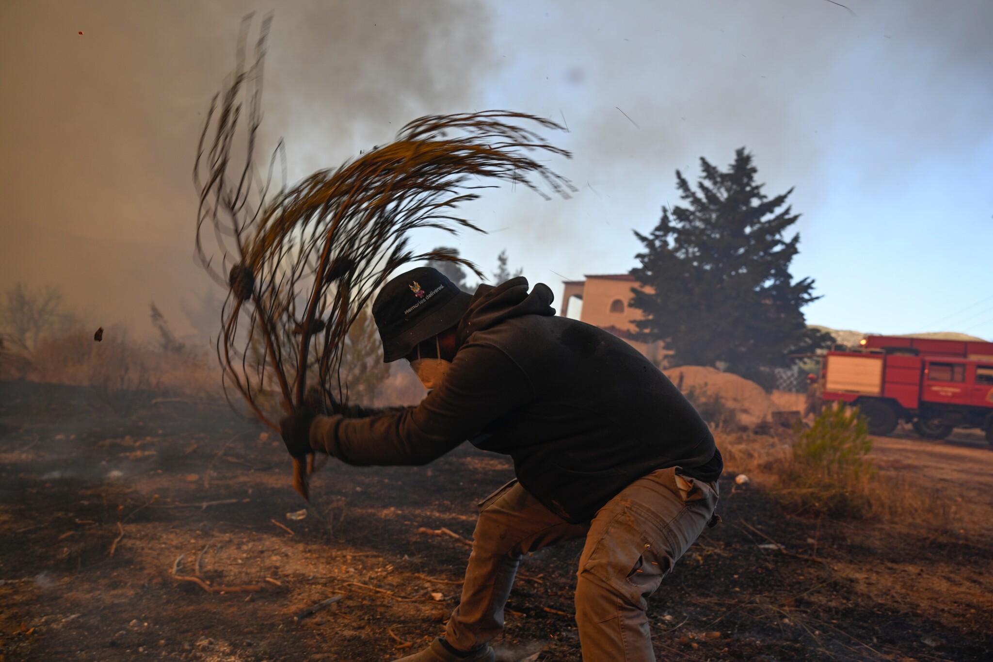 A volunteer tries to extinguish small flames during a wildfire near Porto Germeno, northwest of Athens, Greece, on Aug. 2, 2026. /Michael Varaklas via AP