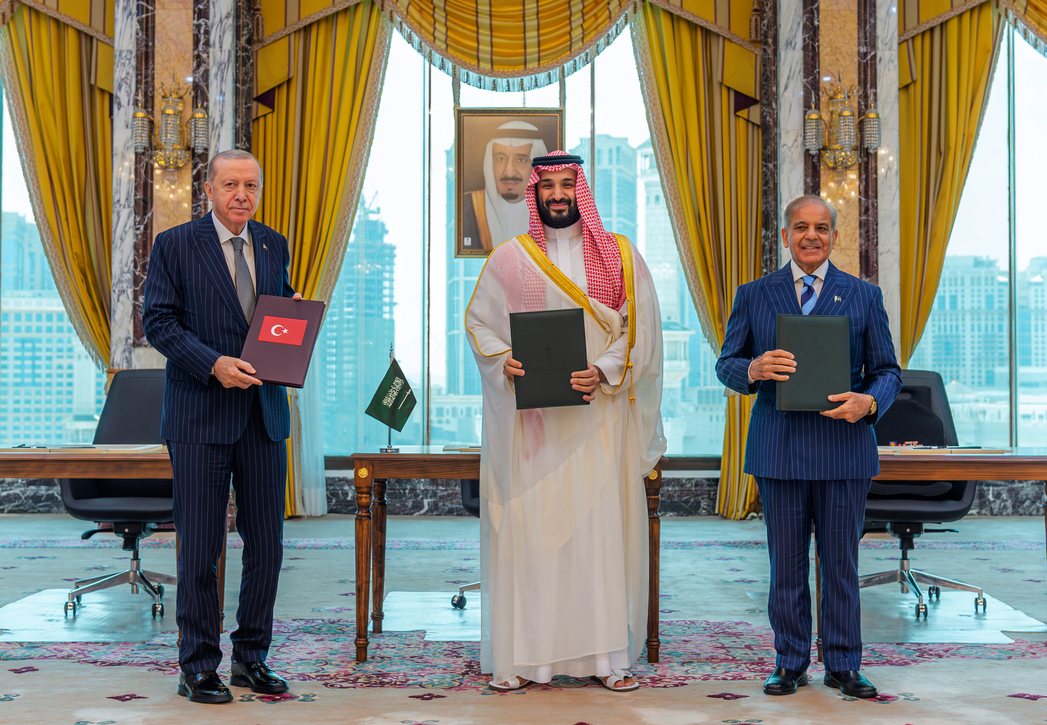 From left, Turkish President Recep Tayyip Erdogan, Saudi Crown Prince Mohammed bin Salman and Pakistani Prime Minister Shehbaz Sharif pose after signing a trilateral defense agreement in Mecca, Saudi Arabia, on Friday. /Saudi Press Agency via AP