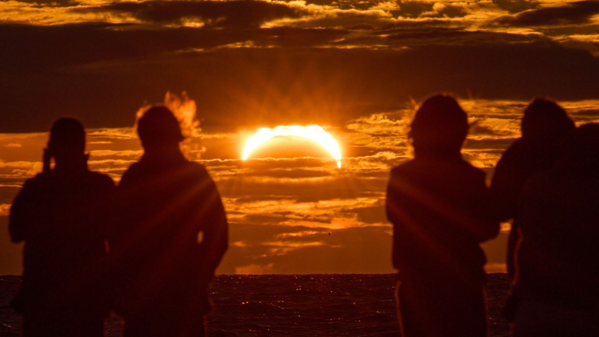 Watching on the shore of the Gulf of Finland in St. Petersburg, Russia – the first European country to witness the eclipse. /Dmitri Lovetsky/AP Photo