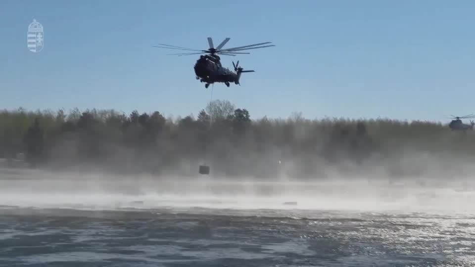 Helicopters assist in operation to sink barges in Danube. /Reuters 