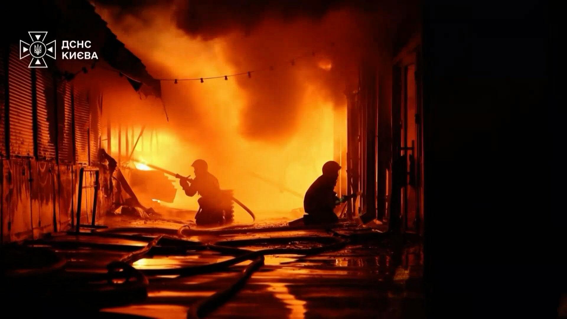 Firefighters extinguish a fire in Kyiv after overnight strike. /AFP
