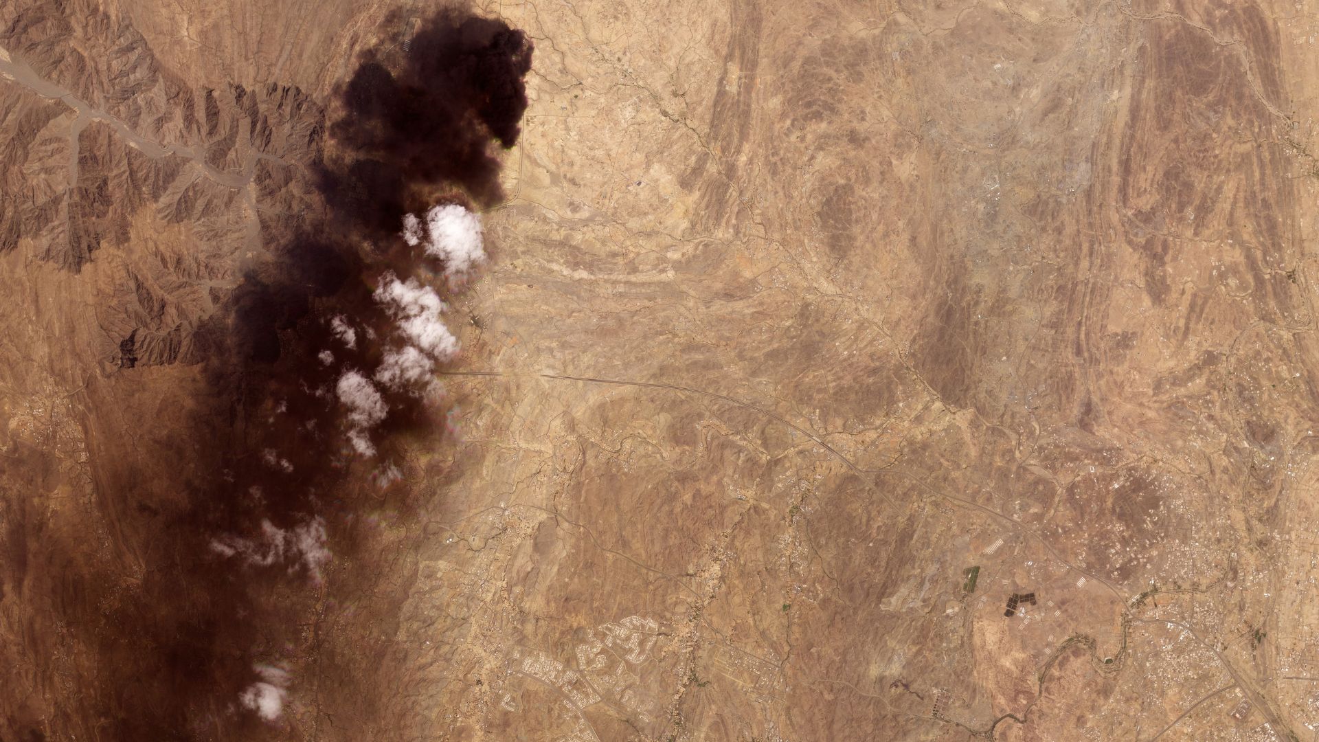 Smoke billows from an Aramco oil depot near the Saudi city of Abha following a Houthi attack. /2026 Planet Labs PBC Handout/AFP