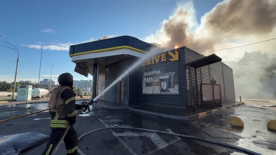 Firefighters work to extinguish a blaze after two gas stations in Kyiv were hit by what an official called Russian drone strikes. /Reuters