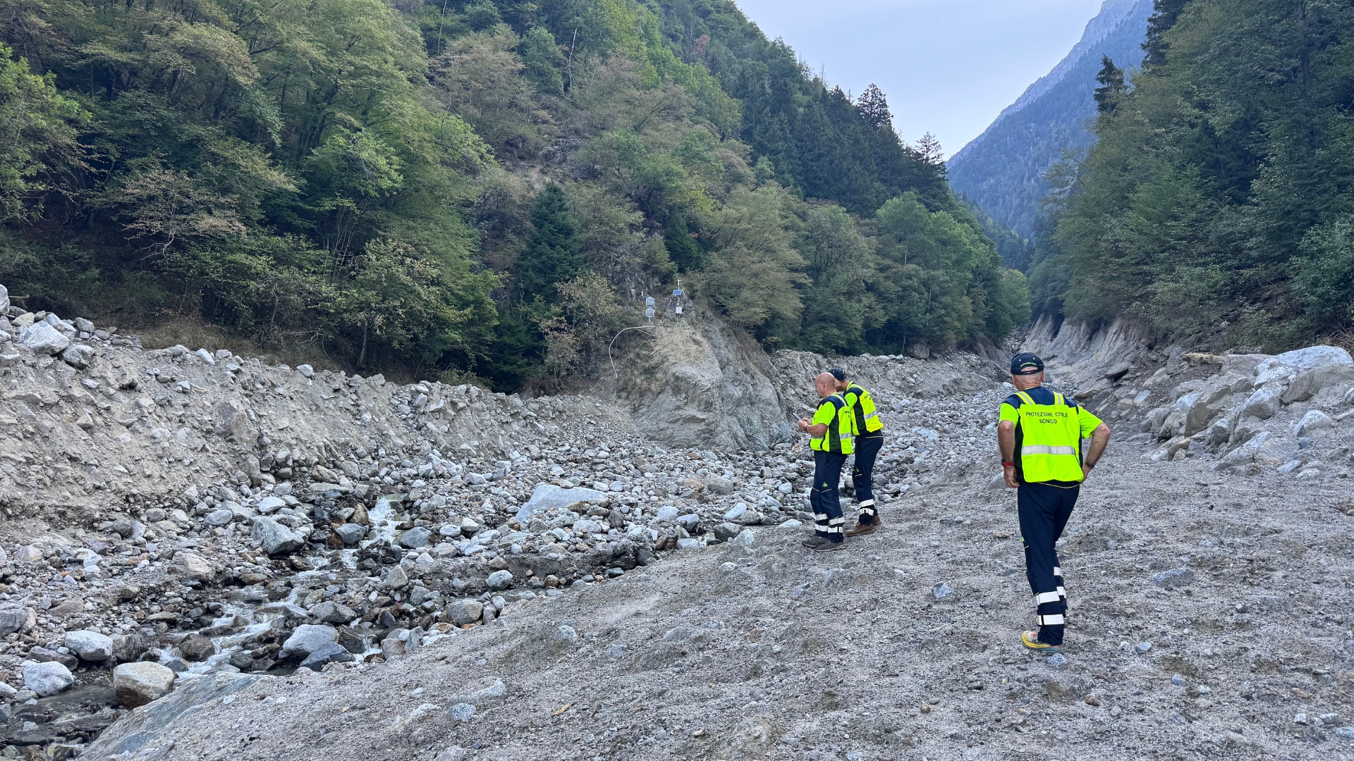Teams in Sonico survey the damage from a bridge collapse, caused by sudden flooding and landslides. /Hermione Kitson.