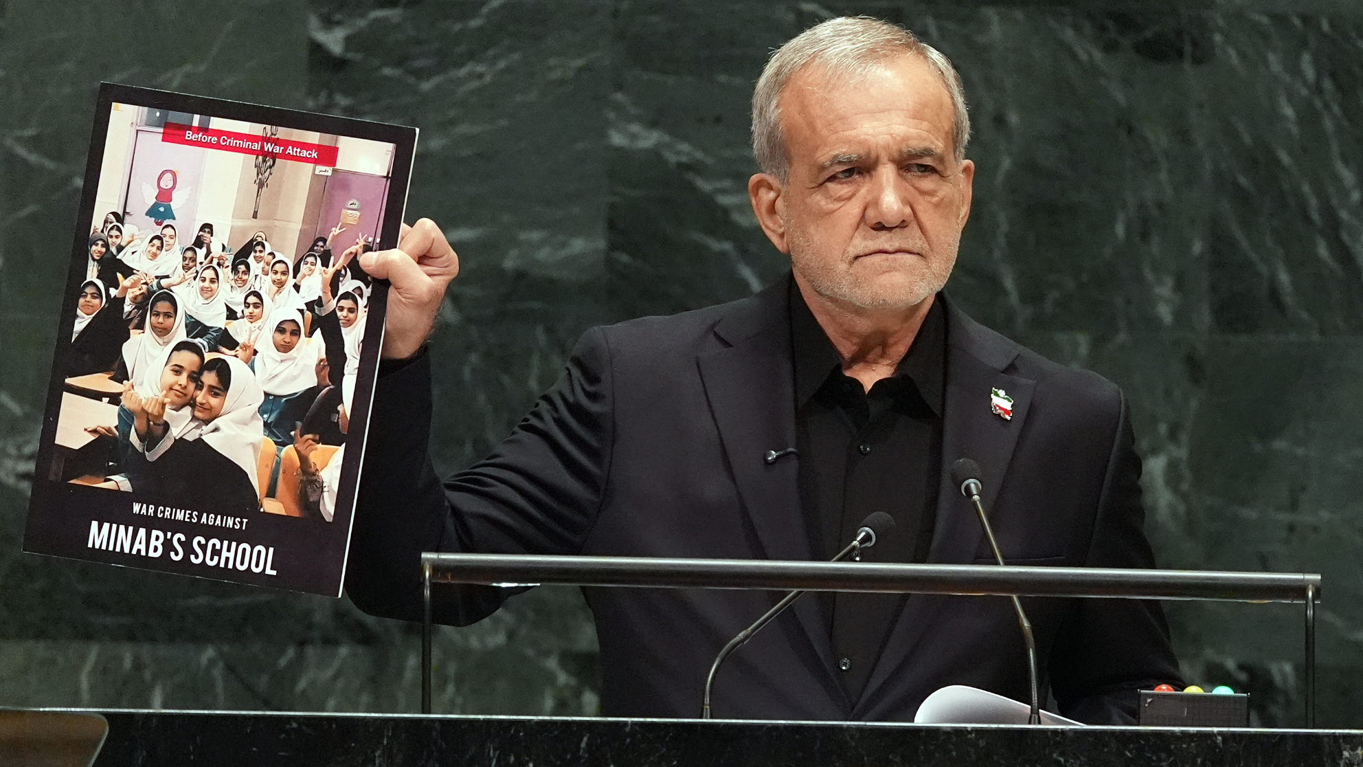 Iran's President Masoud Pezeshkian holds up a photograph as he delivers remarks during the 81st session of the United Nations General Assembly at United Nations headquarters, Wednesday, Sept. 23, 2026. /Heather Khalifa via AP