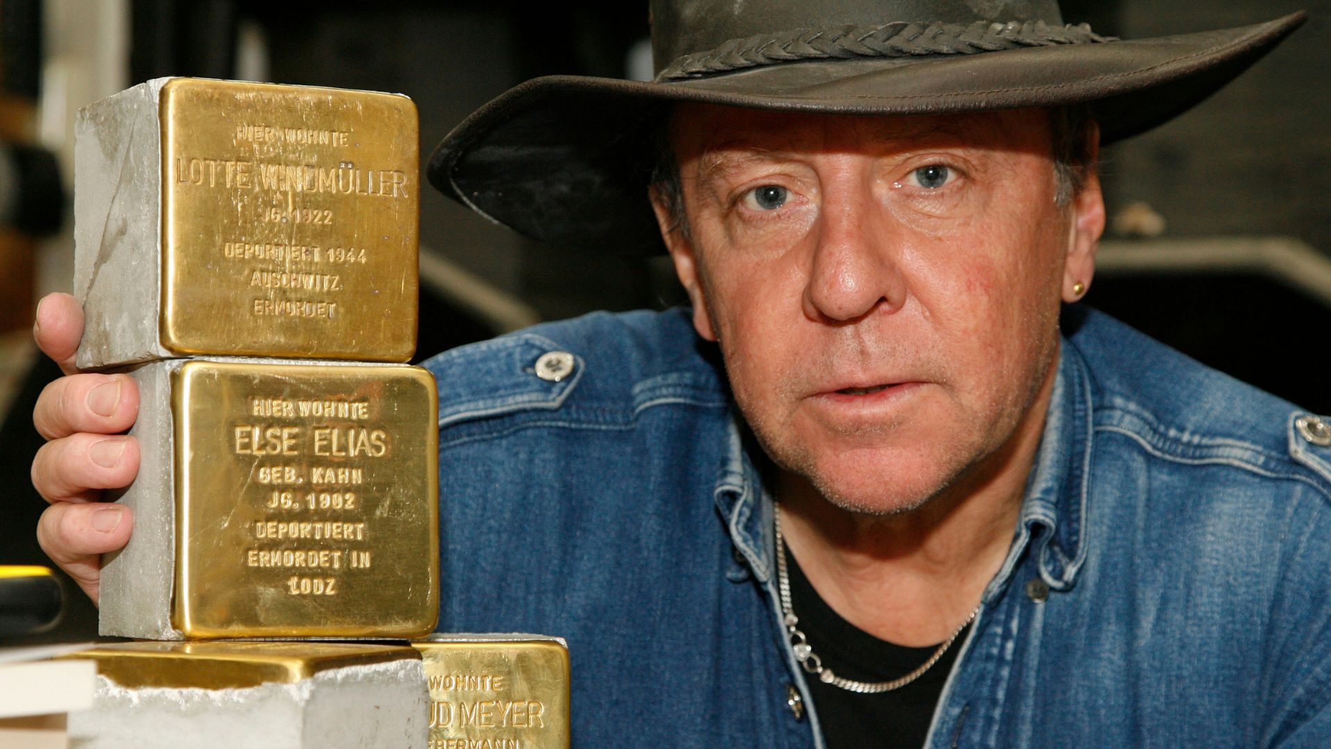 Gunter Demnig, now 78, has been making his Stolpersteine or 'stumbling stones' for three decades. /AP