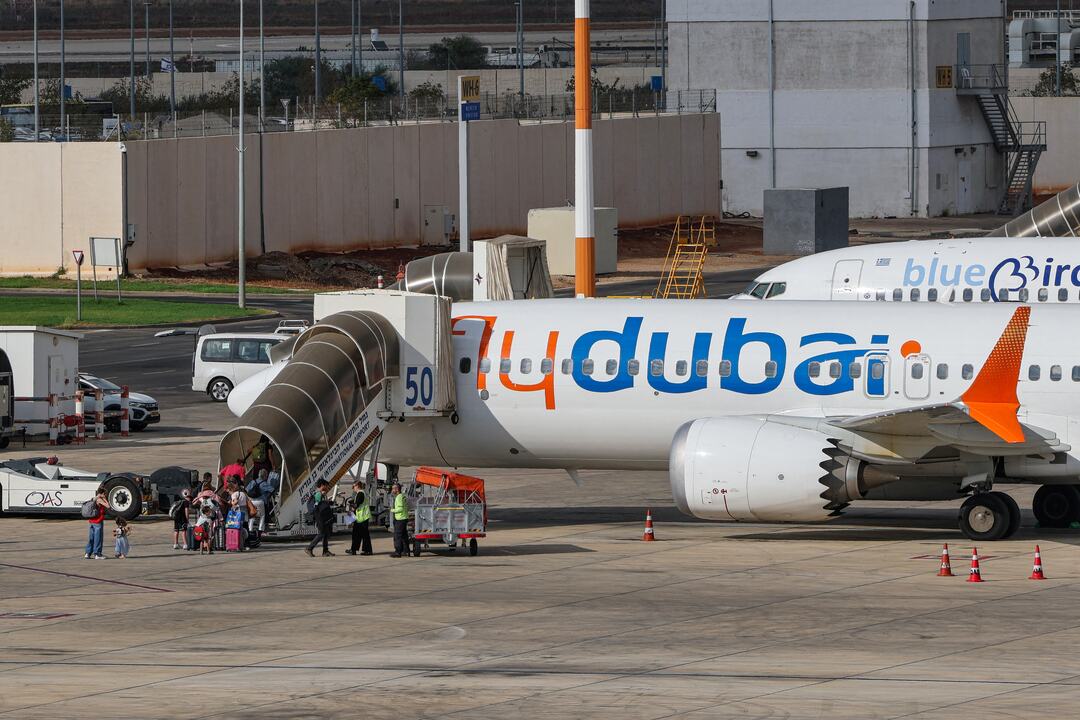 Passengers board a flydubai flight, bound for Dubai. /AFP 