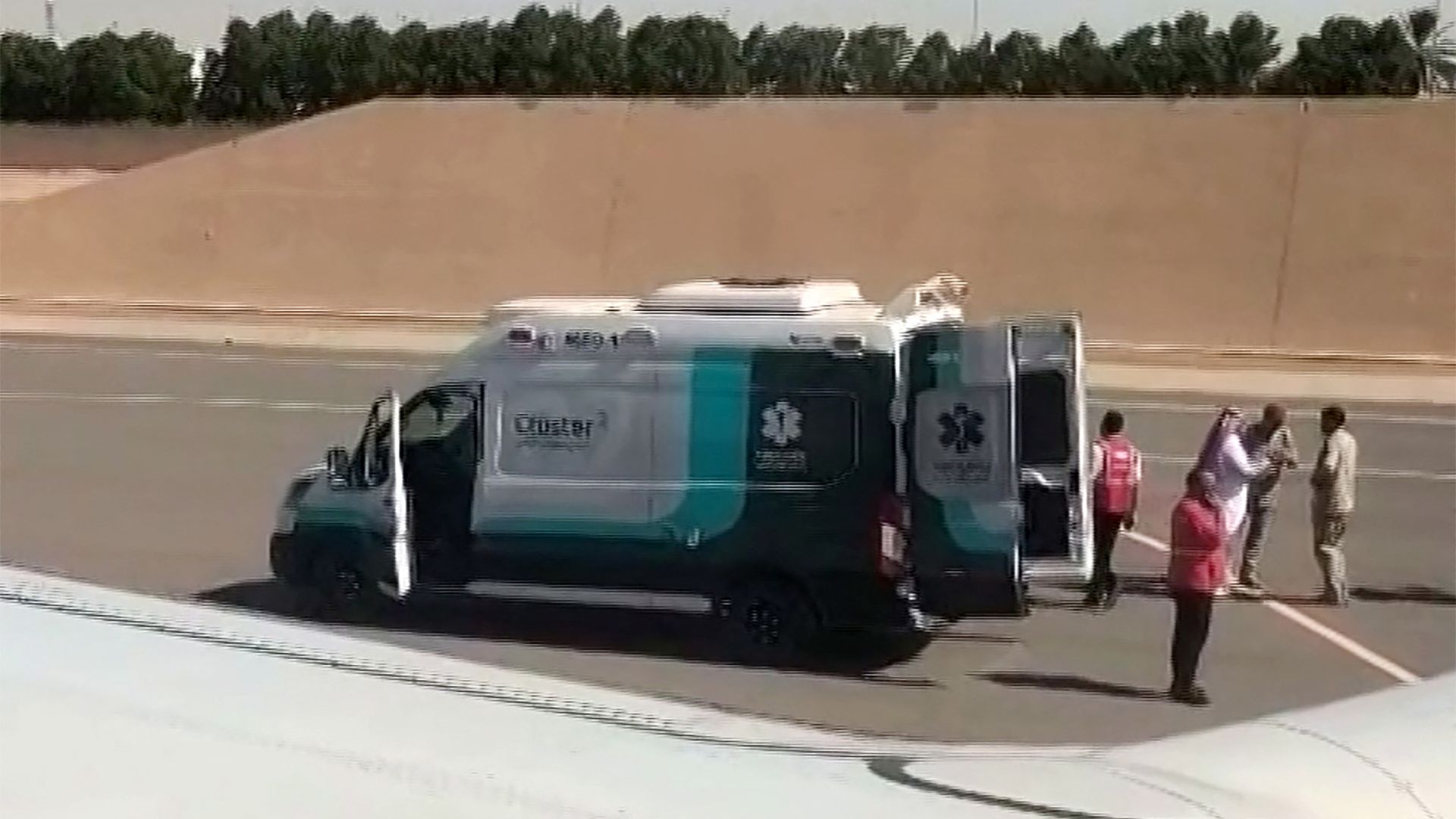 This screengrab shows first responders outside the rerouted FZ1073, ahead of its departure to Tel Aviv from Saudi Arabia’s Tabuk airport. /AFPTV/AFP