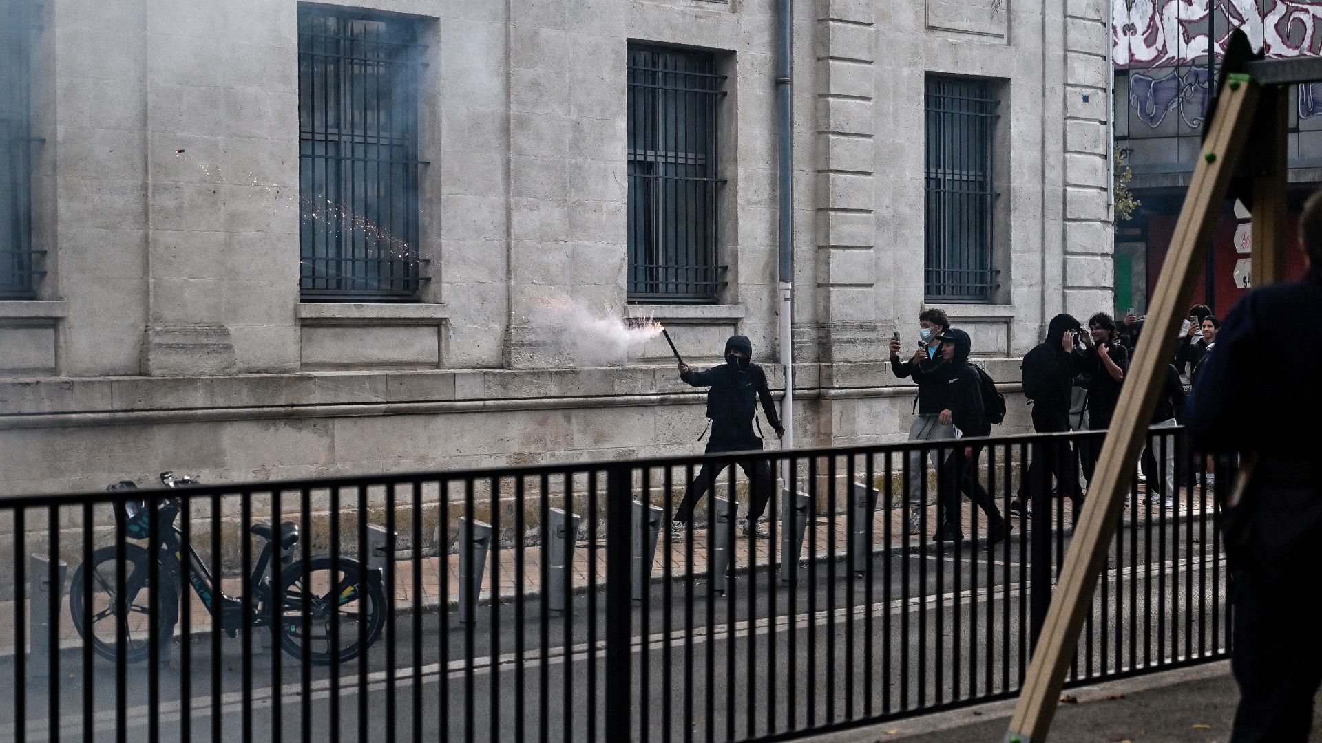 A protester uses a fireworks mortar during clashes between high school students and riot policemen in Bordeaux on October 5. /Christophe Archambault/AFP
