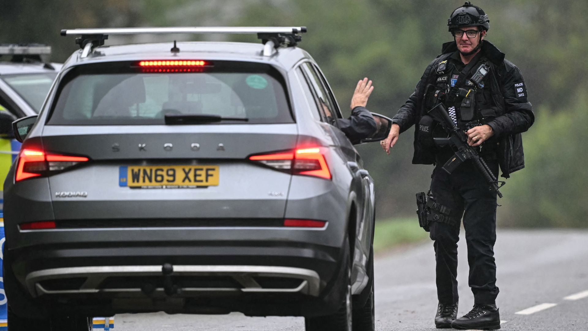 A car is stopped as police man a roadblock while posted outside RAF Fairford base in Fairford, south-west England on September 27, as UK counter-terrorism police investigate an incident near the base. /Justin Tallis/AFP