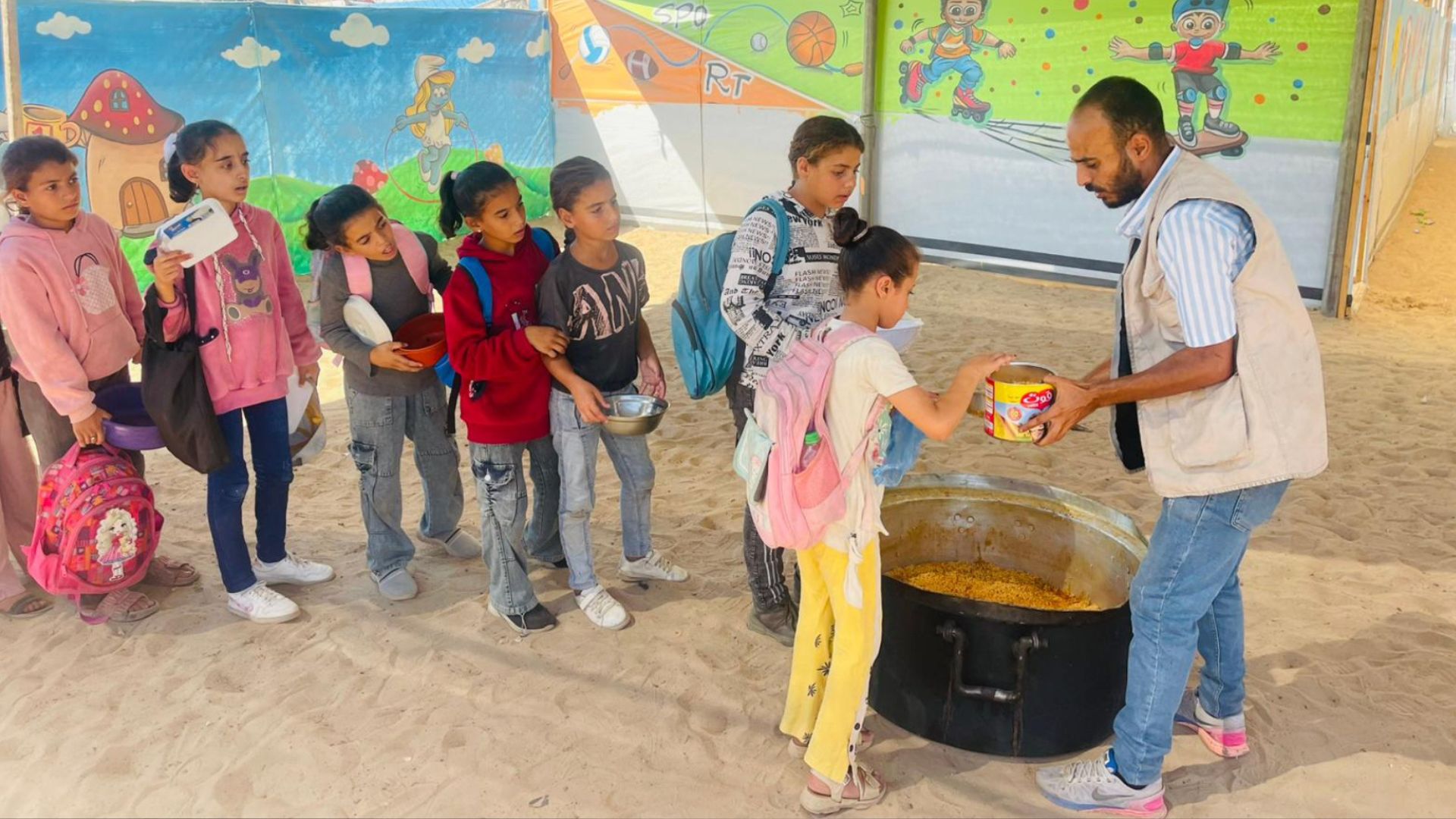 Children at the Academies of Hope campus in Gaza queue for food. /Gaza Children Village website.
