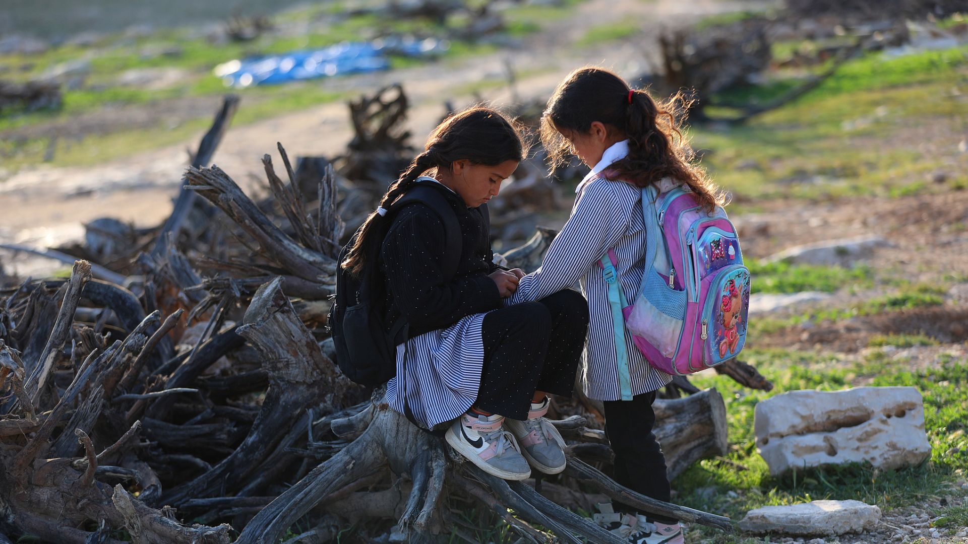 Palestinian students attend an outdoor lesson on the street in Hebron, West Bank, on April 14, 2026, after Israeli settlers blocked the road leading to their school in the village of Ummul Khayr. /Wisam Hashlamoun/Anadolu via Getty Images
