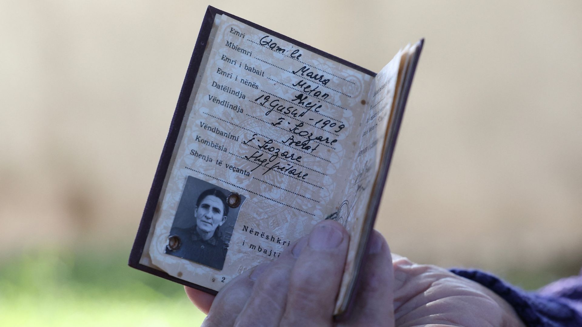 Marra shows an identity document showing her birthdate as 1909. /Adnan Beci/AFP
