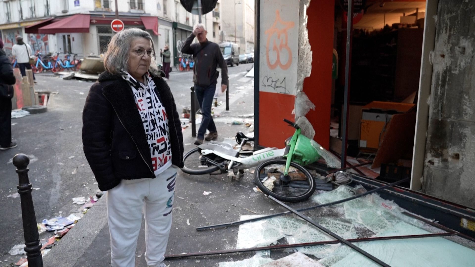 A Paris resident looks on at the substantial damage left behind by protestors. /Reuters.