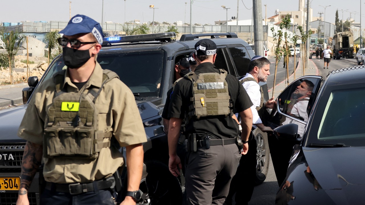 Far-right Israeli Finance Minister Bezalel Smotrich visits the scene of an earlier fire exchange between armed Palestinians and Israeli forces following an incident at the norther checkpoint of Hebron in the Israeli-occupied West Bank. /Ahmad Gharabli/AFP