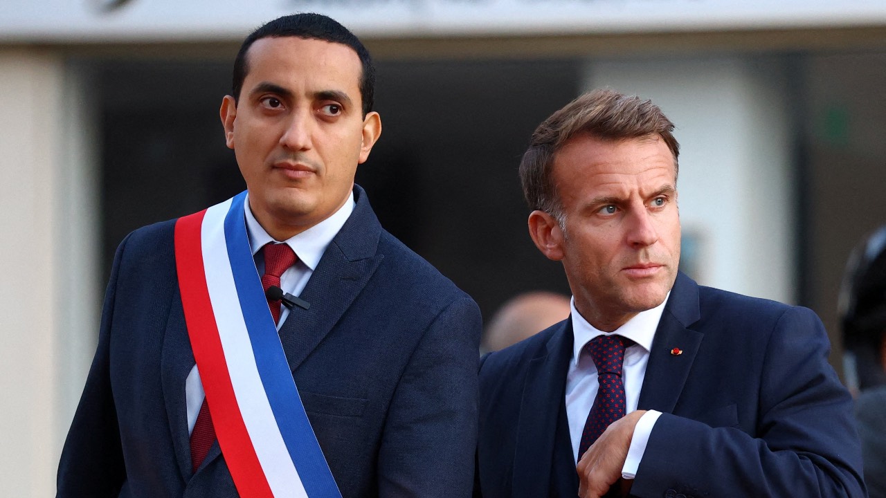 France's President Emmanuel Macron (R) walks with Mayor of Trappes Ali Rabeh as he arrives for a meeting at the town hall following a shooting in Trappes, near Paris. /Hannah McKay/AFP