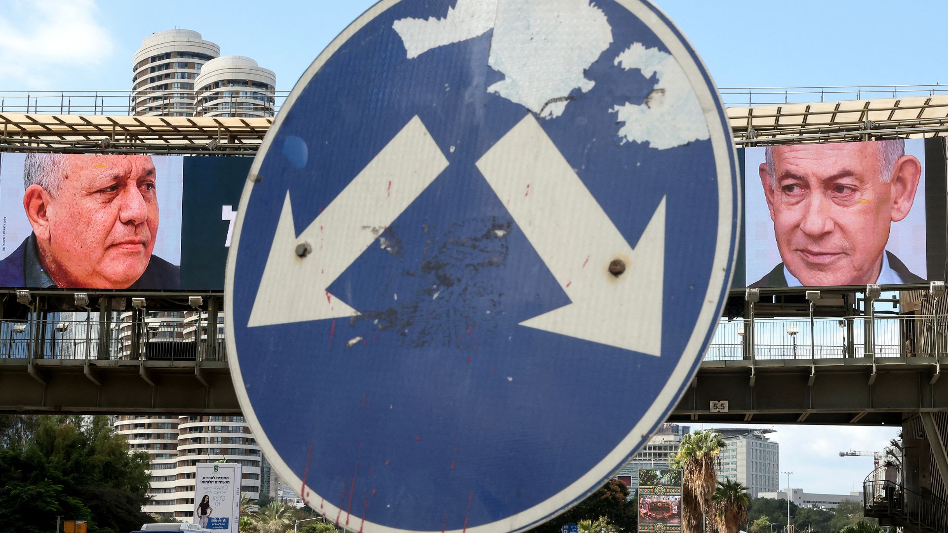 Which way next for Israel? A road sign stands in front of billboards featuring Eisenkot and Netanyahu. /Jack Guez/AFP